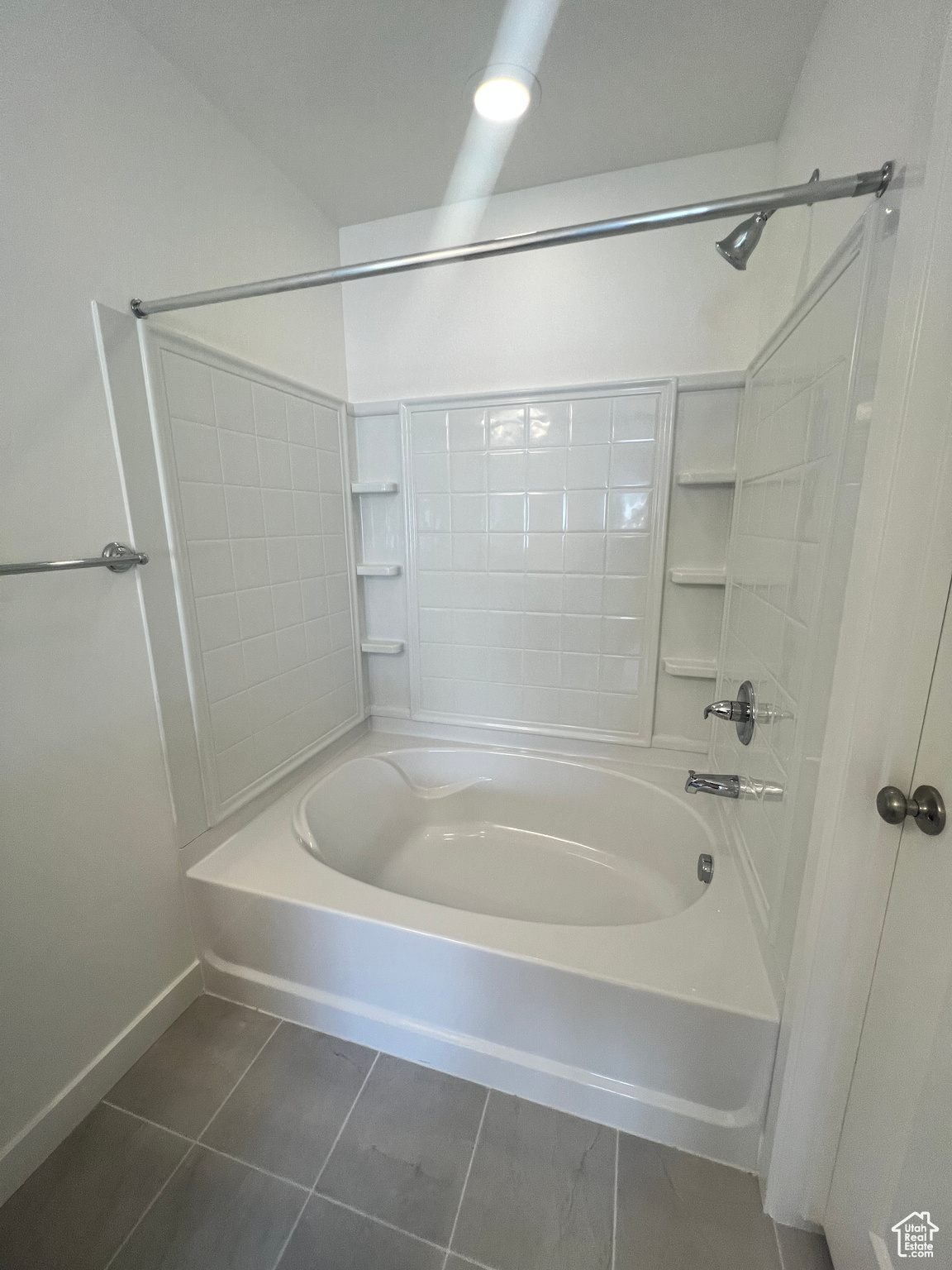 Bathroom with tile patterned floors and  shower combination