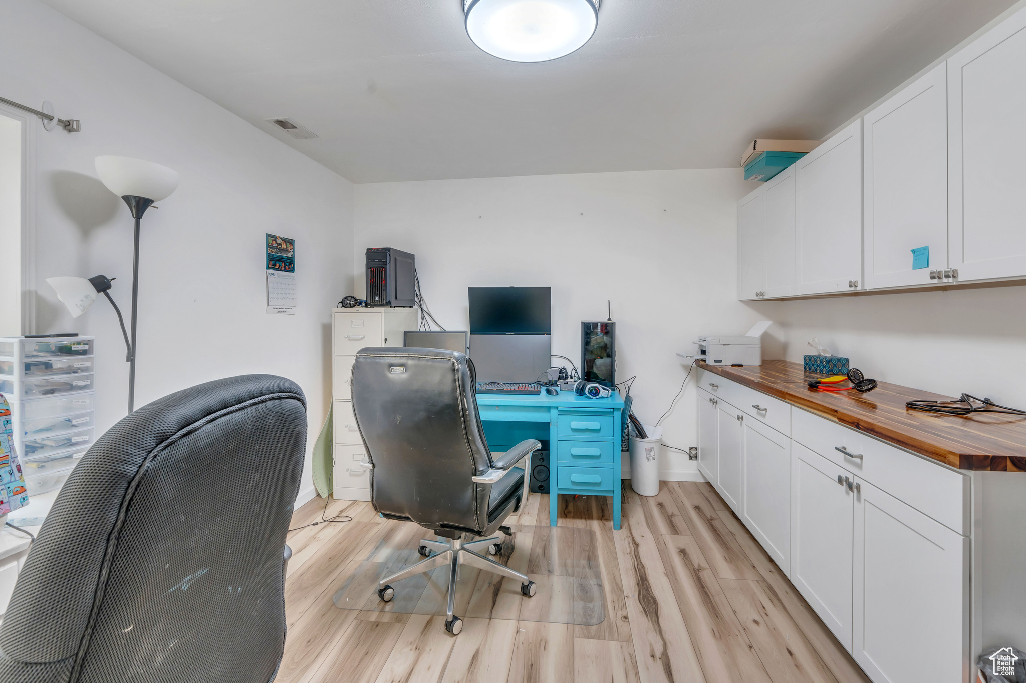 Office with light hardwood / wood-style flooring