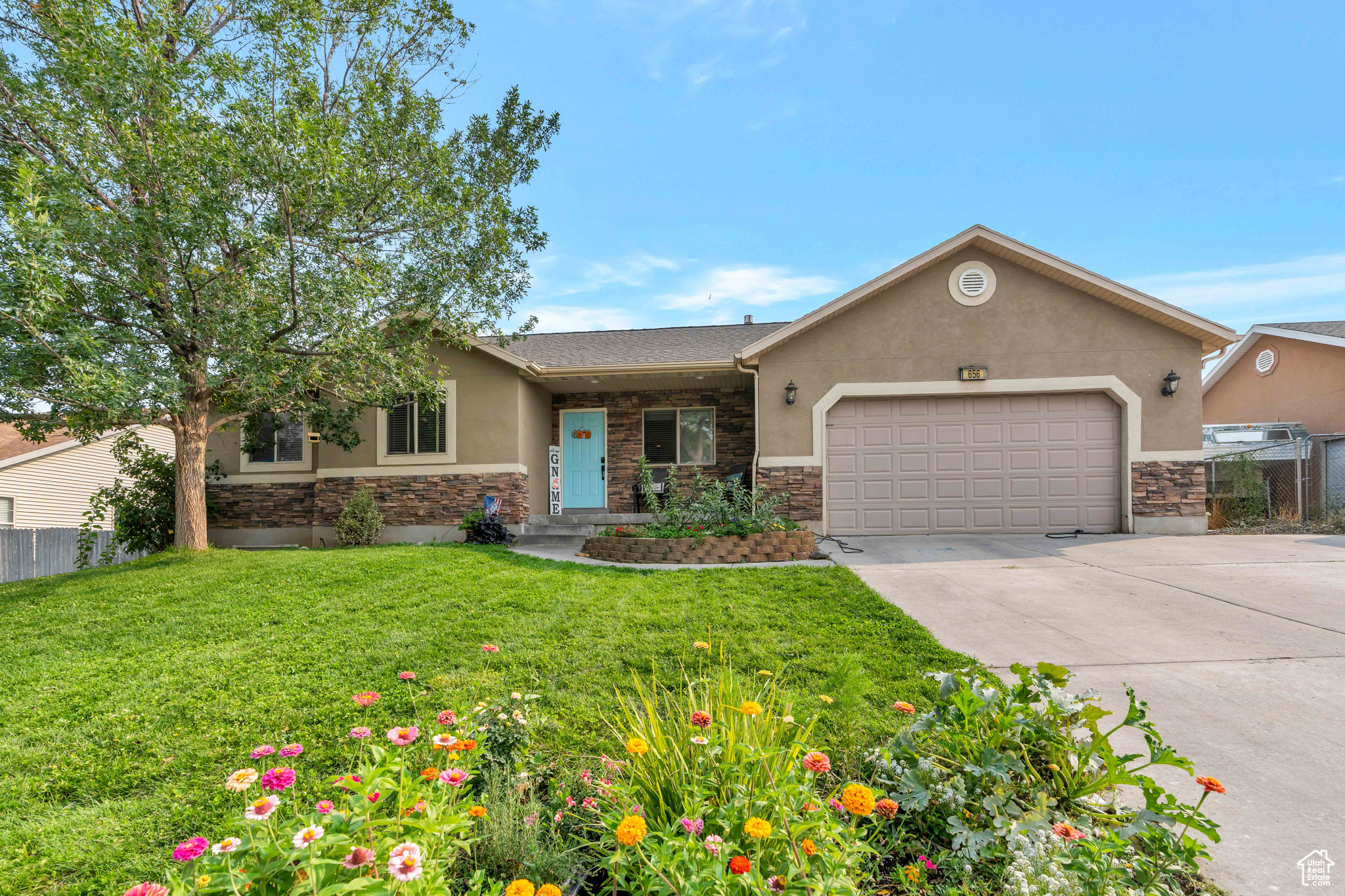 View of front of home with a front lawn and a garage