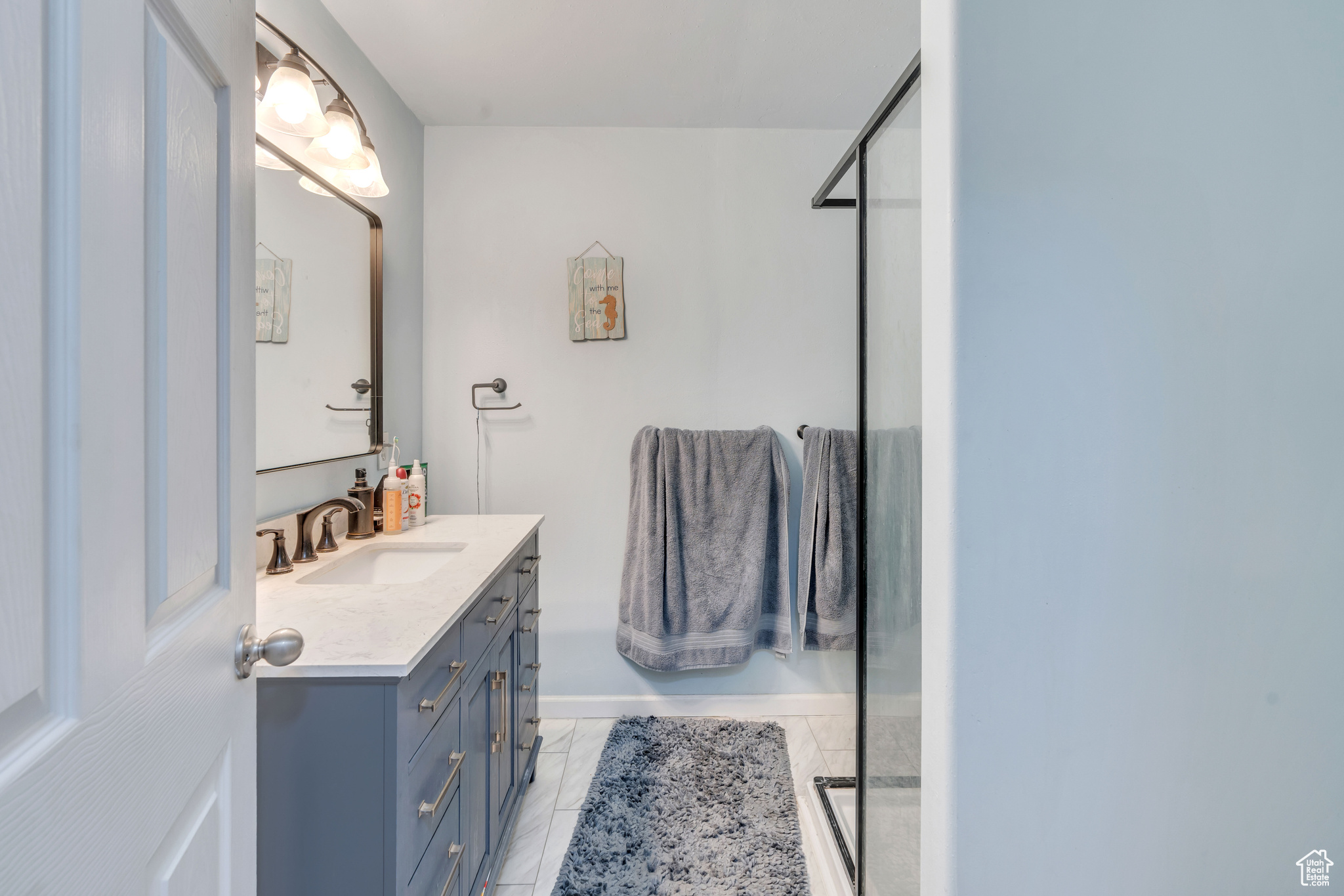 Bathroom with vanity, walk in shower, and tile patterned floors