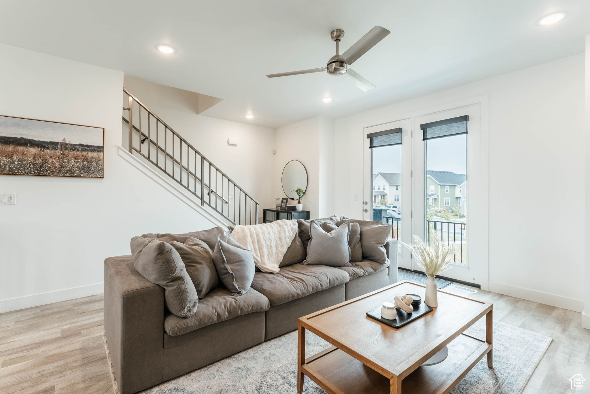 Living room featuring light wood-type flooring and ceiling fan