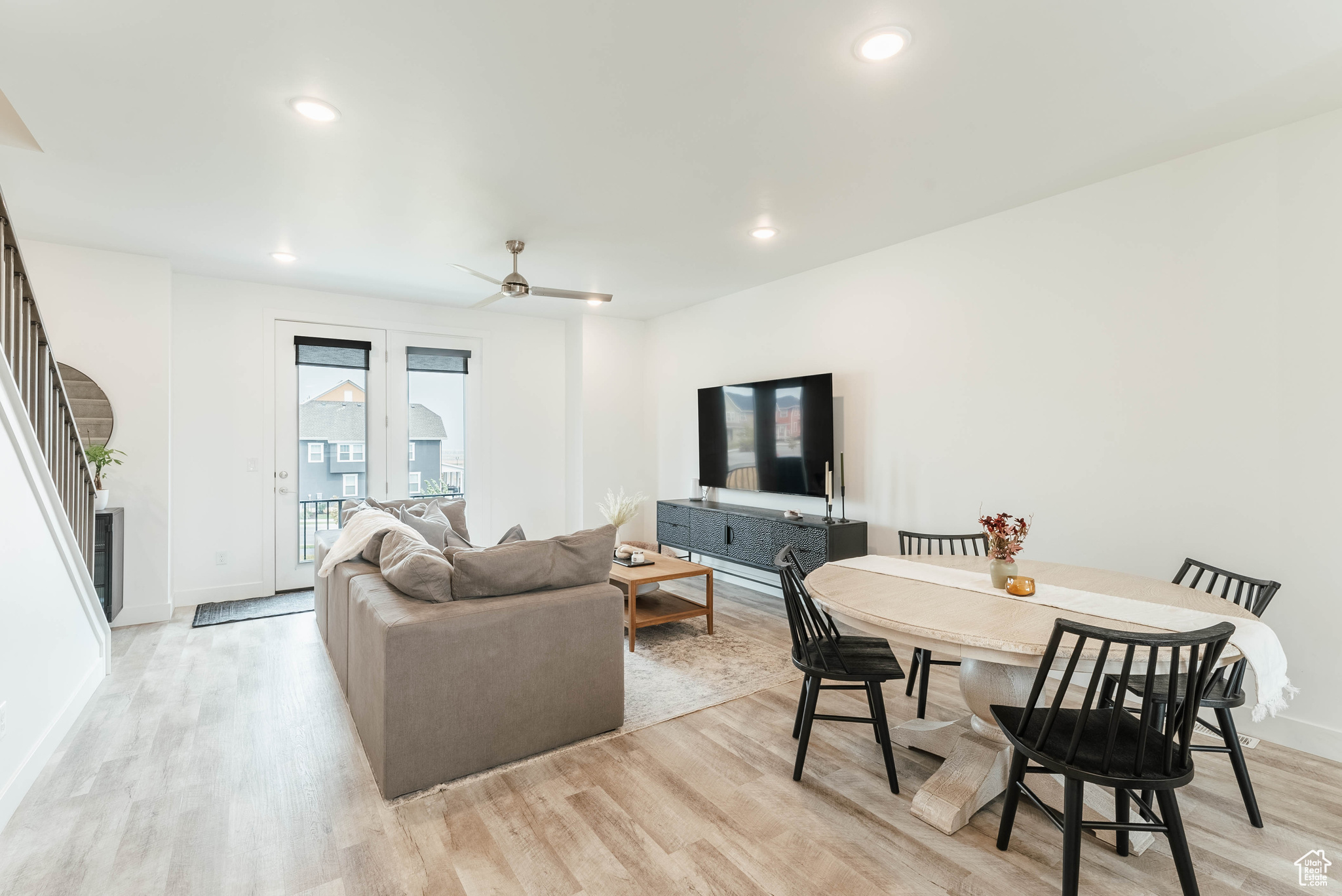 Living room featuring ceiling fan and light hardwood / wood-style flooring