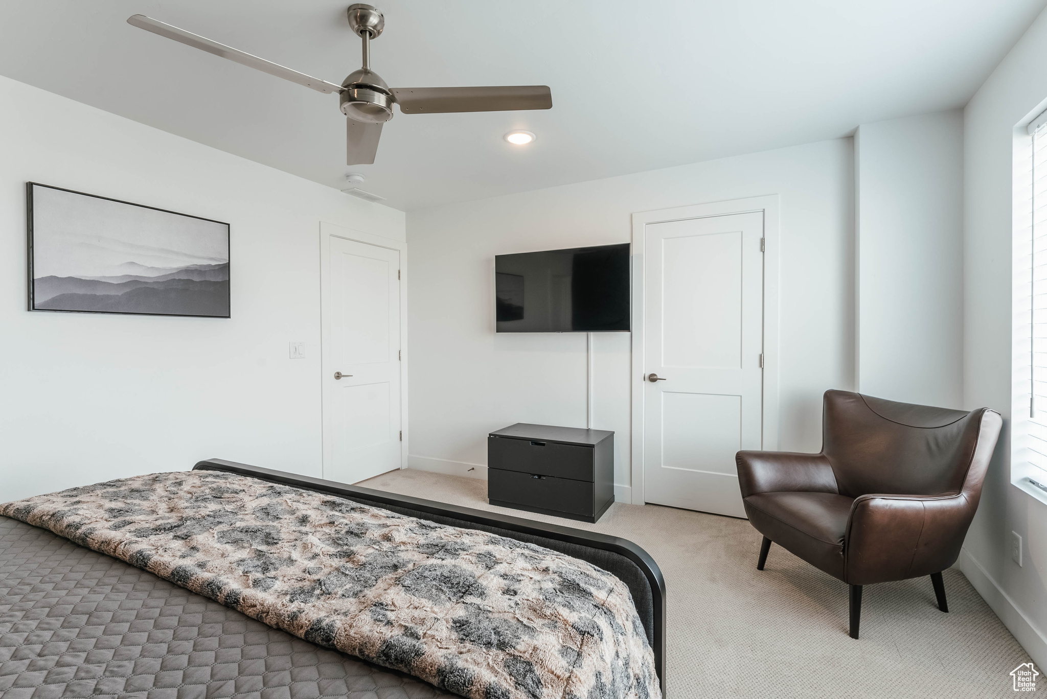 Carpeted bedroom with ceiling fan