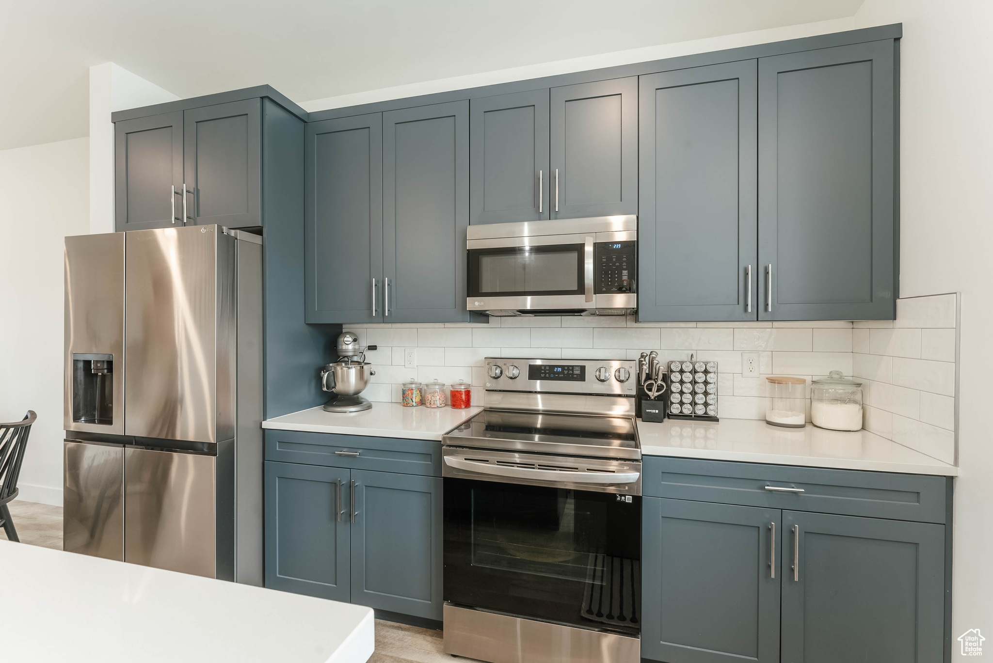 Kitchen featuring appliances with stainless steel finishes and backsplash