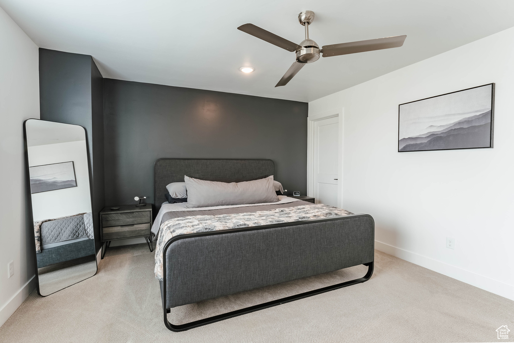 Bedroom featuring light carpet and ceiling fan