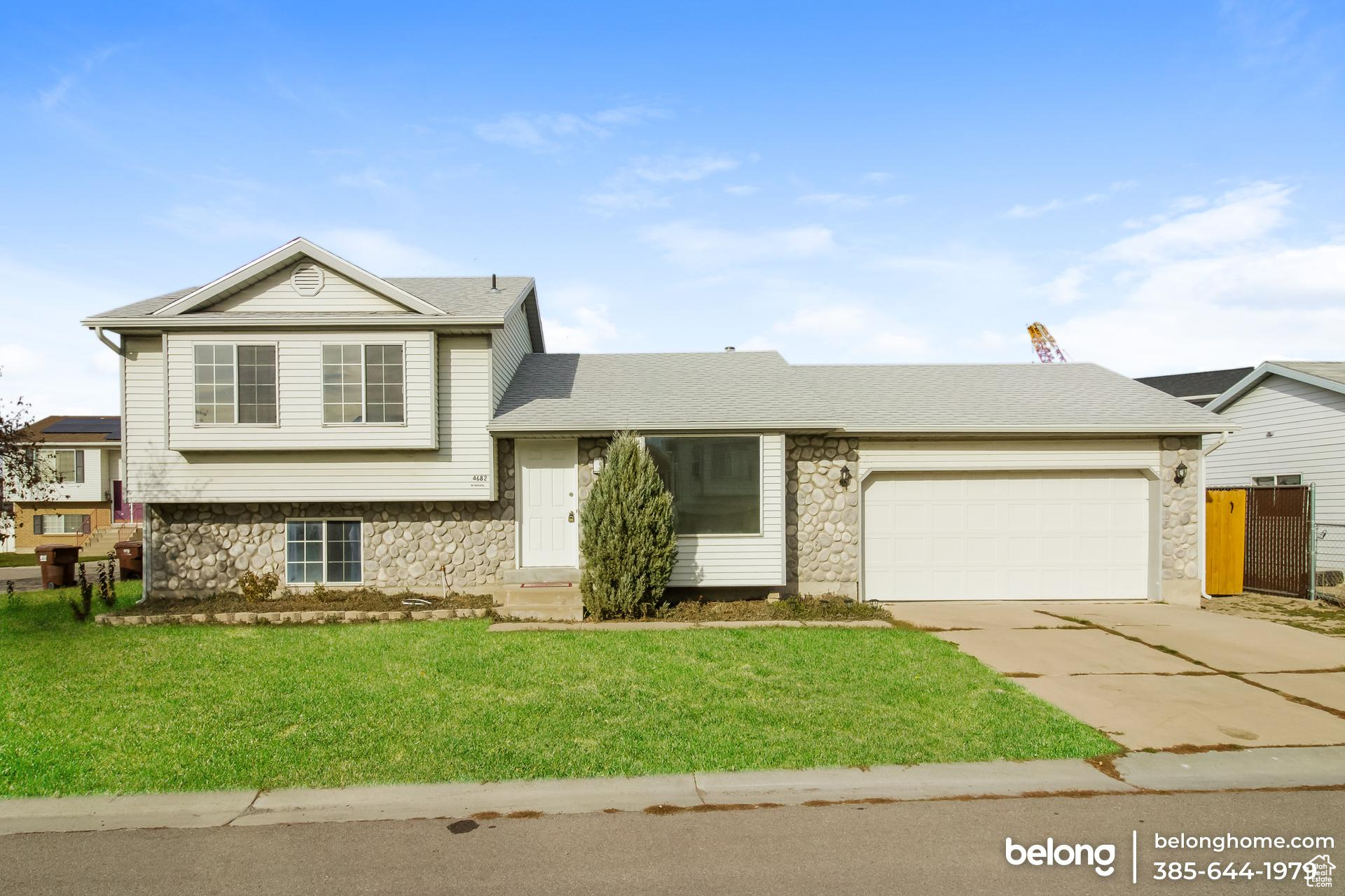 View of front of house featuring a front yard and a garage