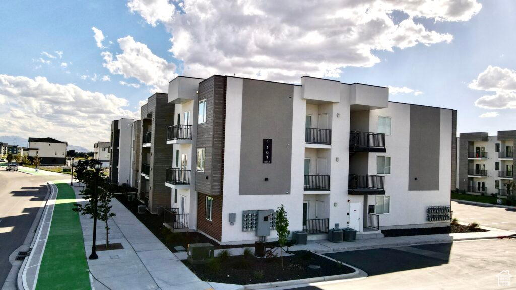 View of property with central AC unit