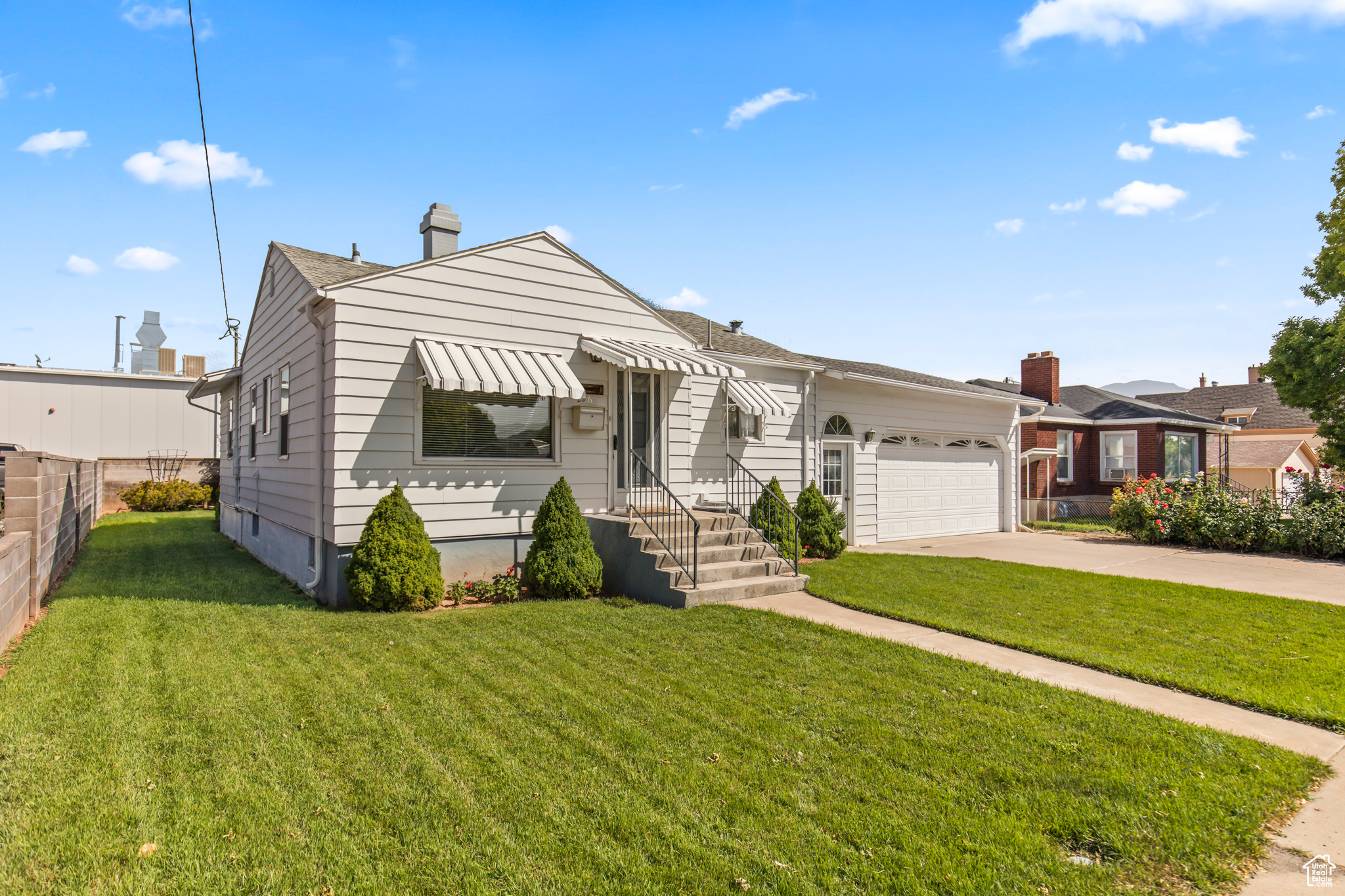 View of front of house featuring a garage and a front yard