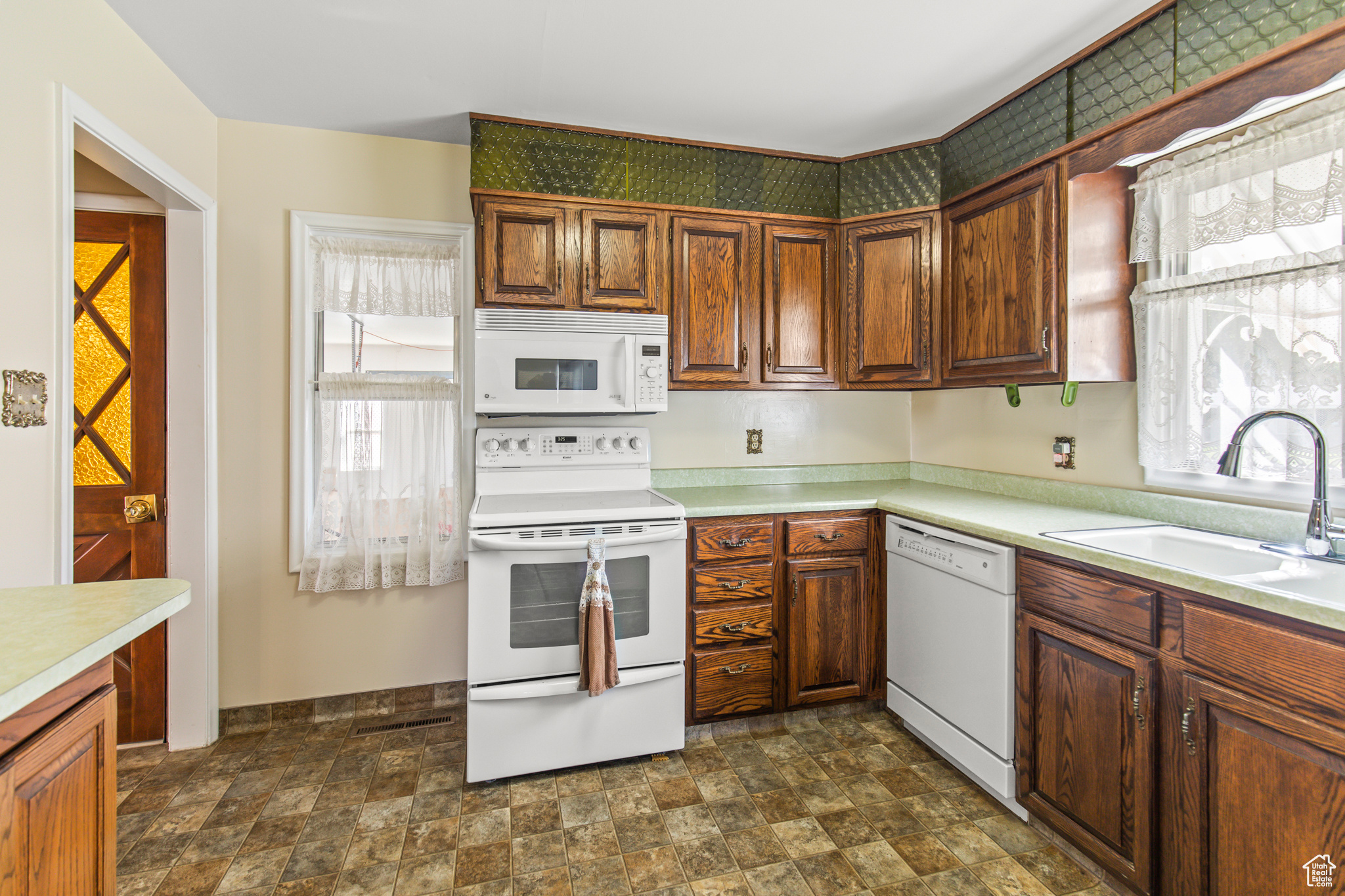 Kitchen with white appliances and sink