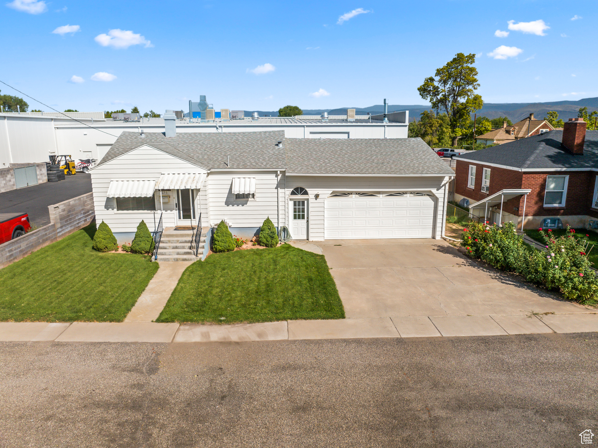 View of front of house with a front yard and a garage