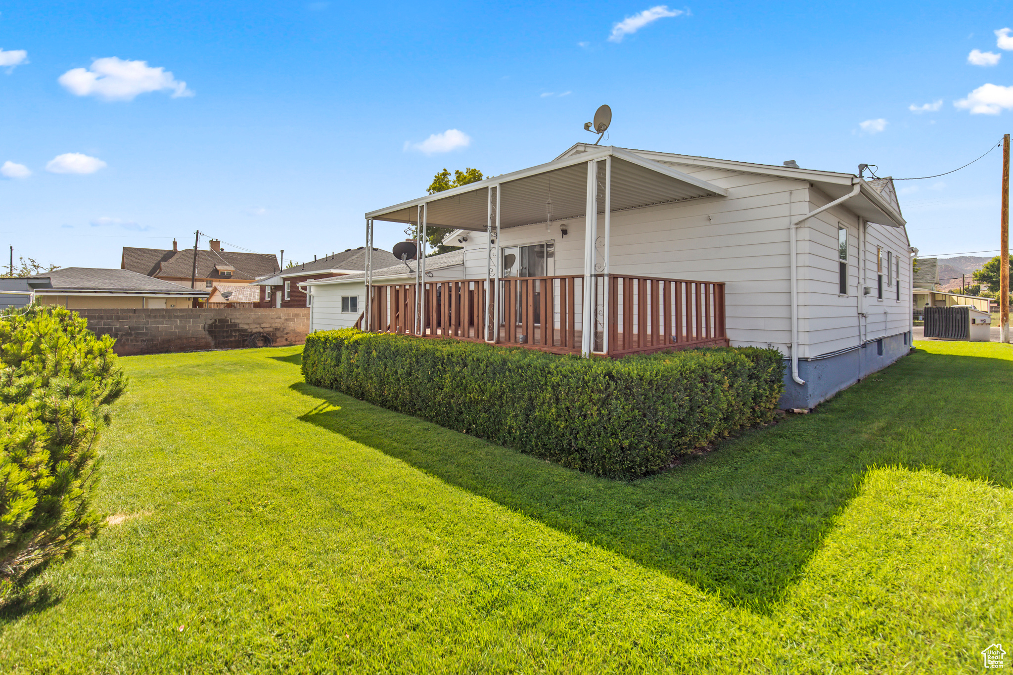 Back of house with a yard