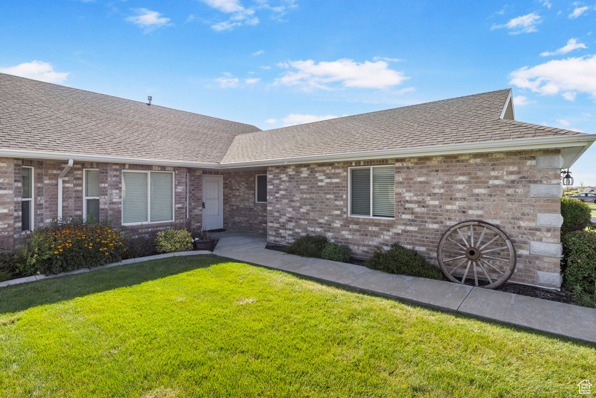 Ranch-style home featuring a front lawn