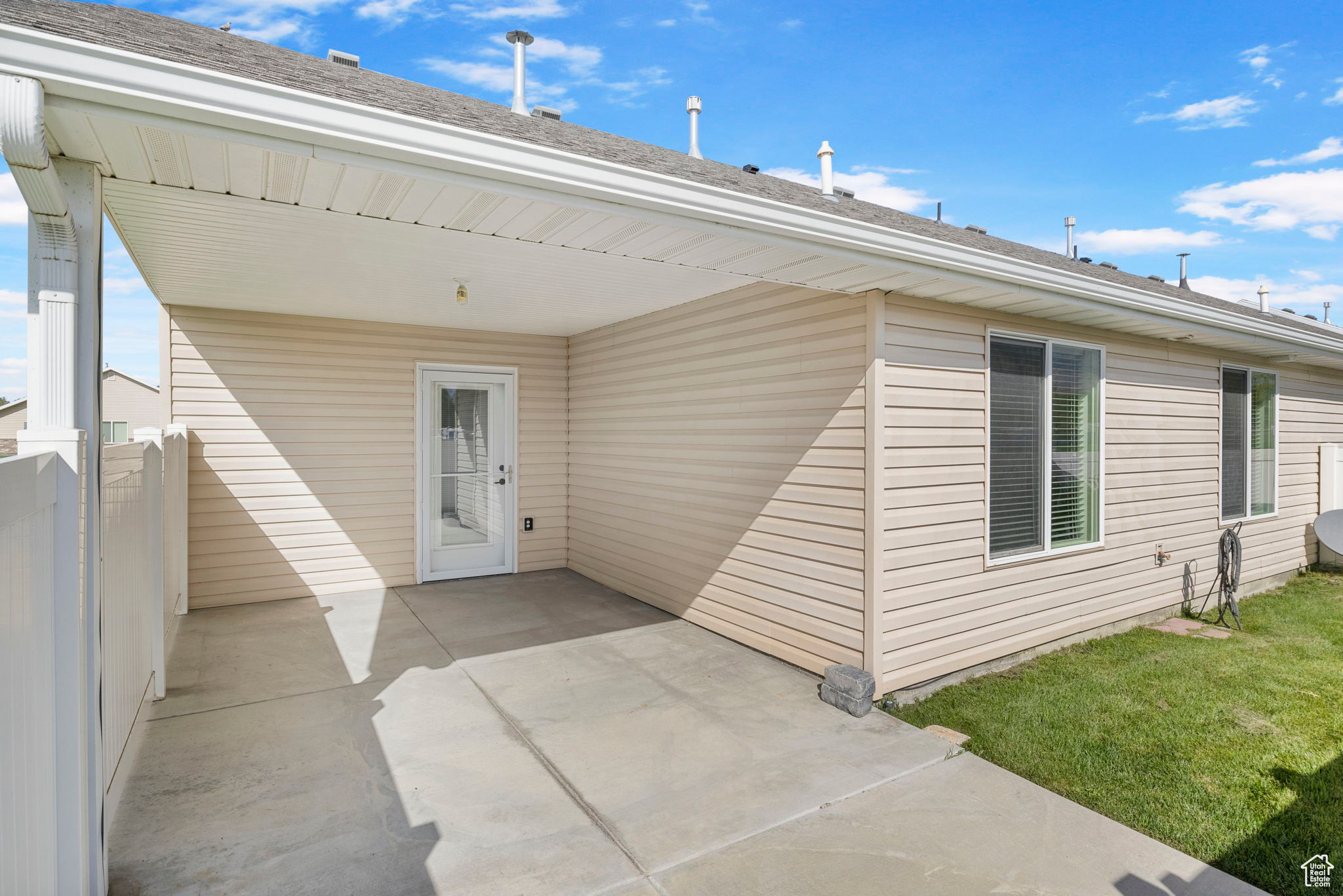 View of exterior entry with a patio