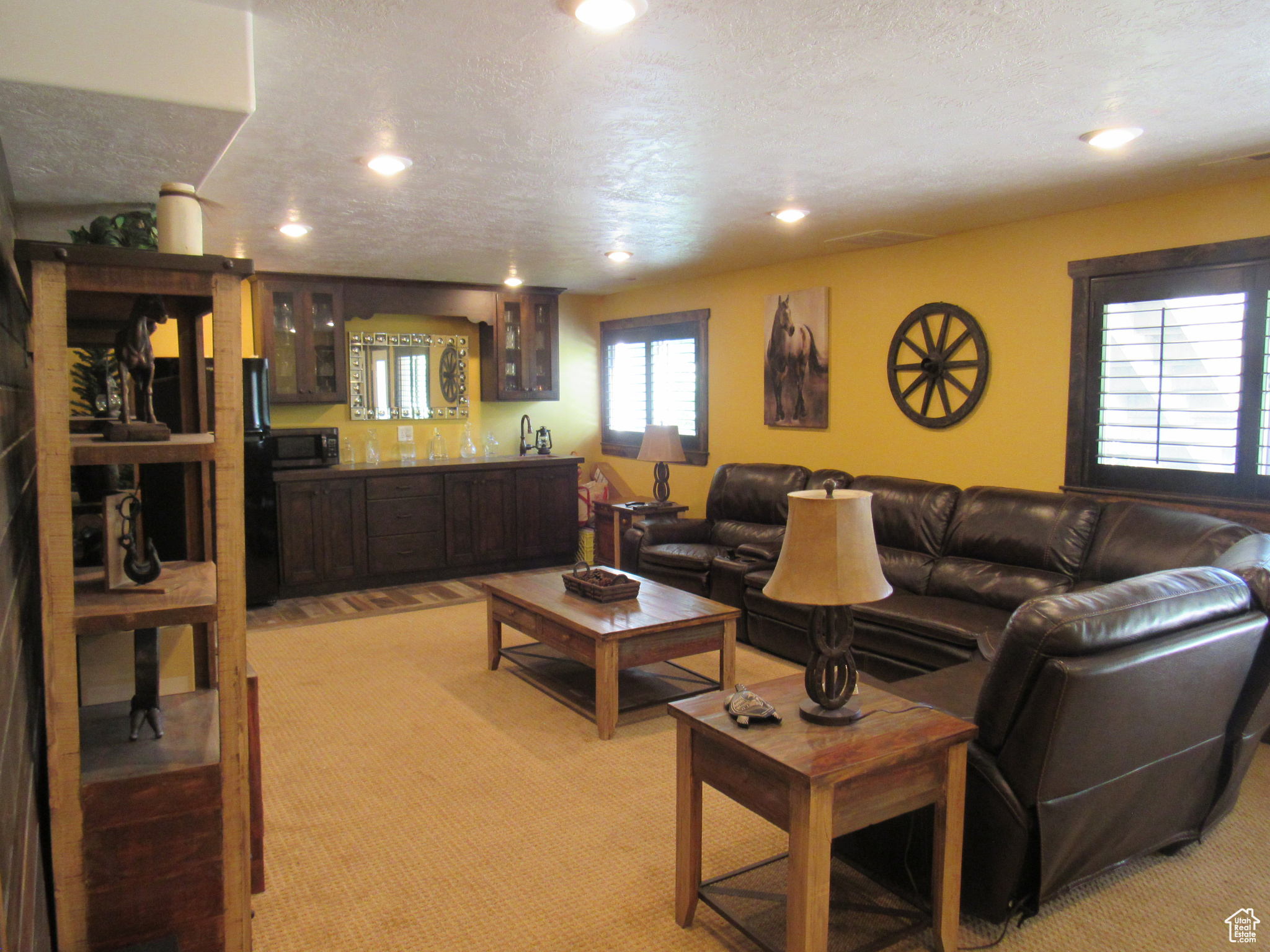 Living room featuring light carpet and a textured ceiling