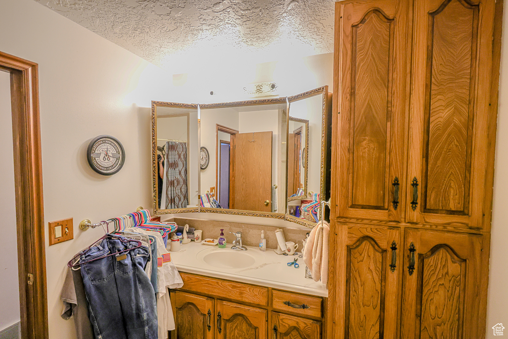 Bathroom featuring a textured ceiling and vanity