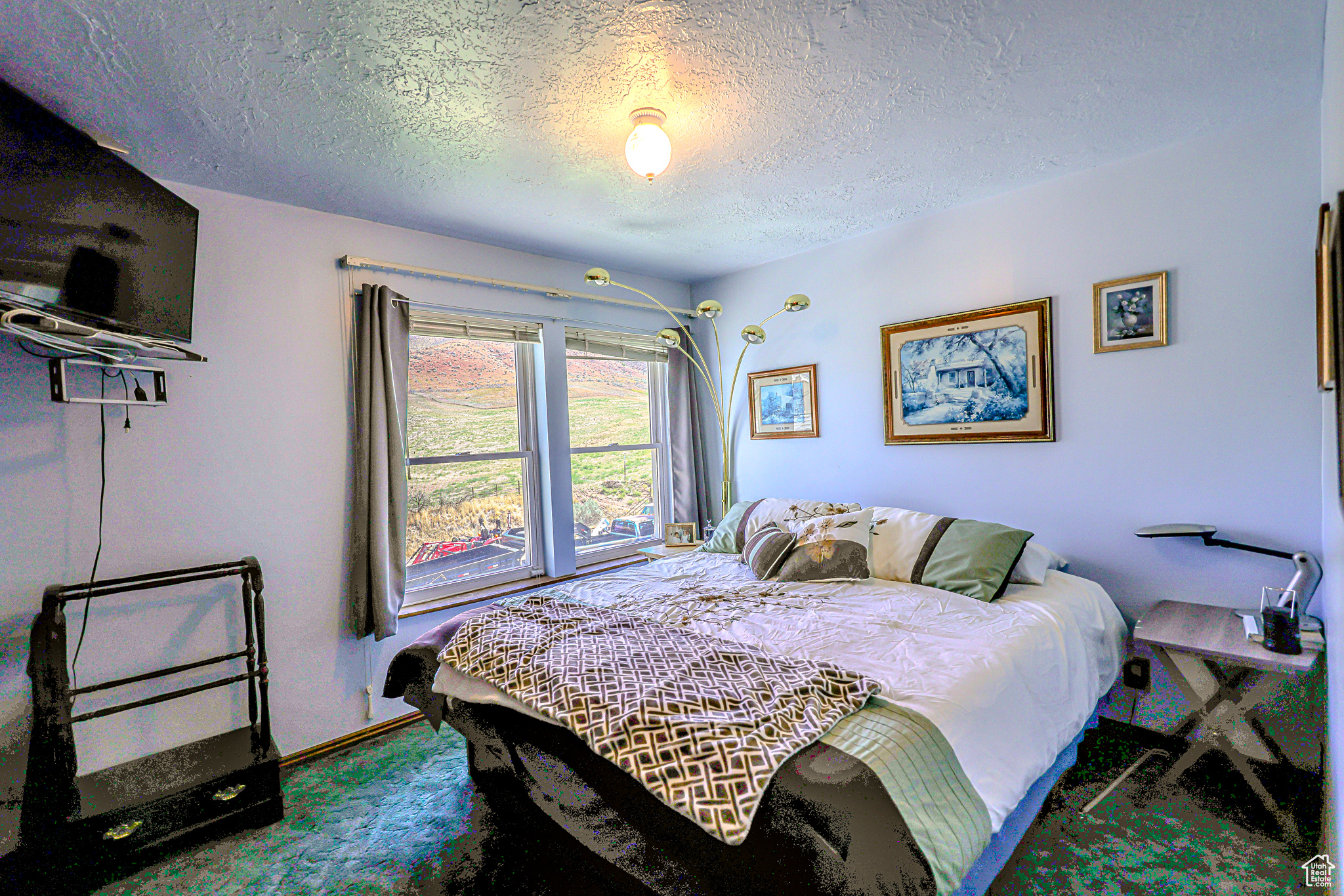 Bedroom featuring a textured ceiling and carpet