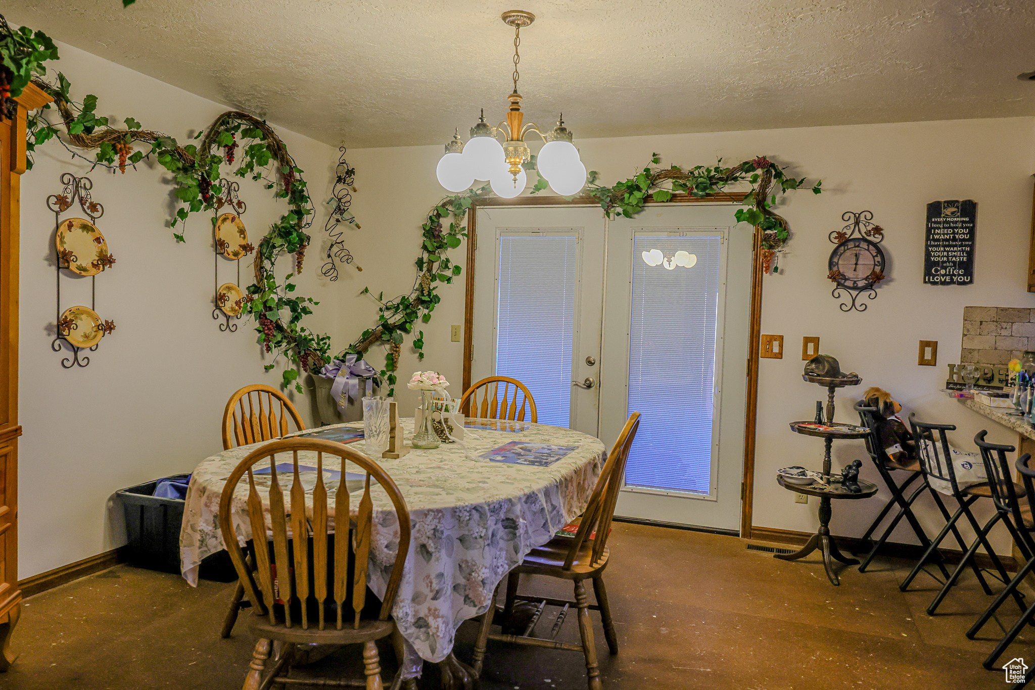 Dining room with a textured ceiling and a chandelier