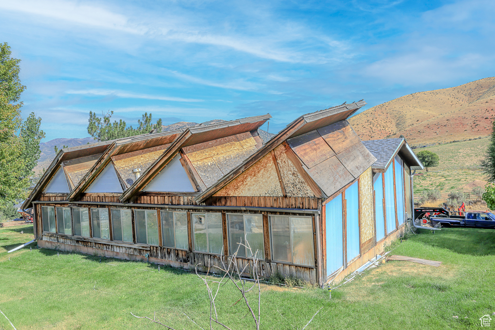 Exterior space with a mountain view and a lawn