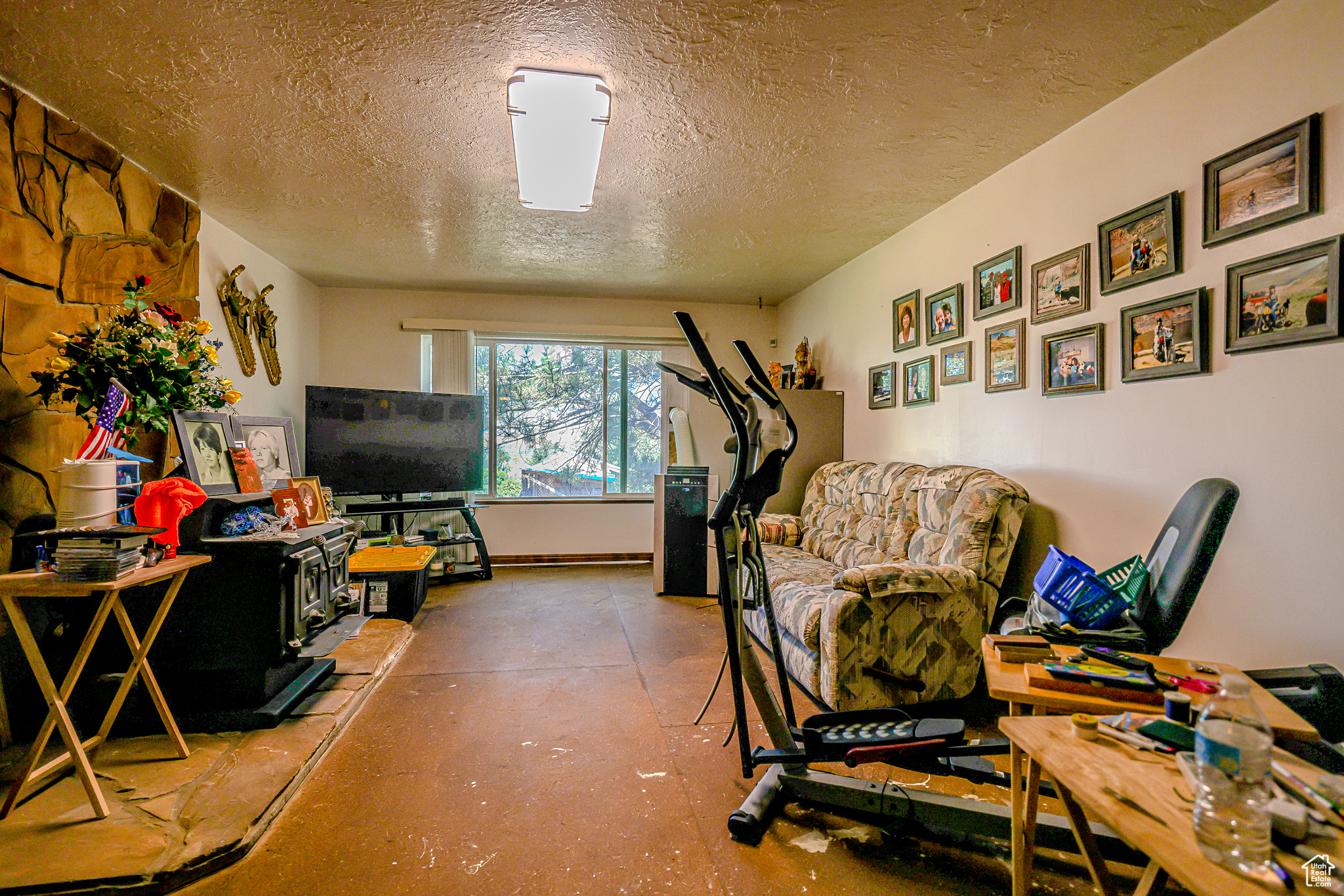 Interior space featuring a wood stove and a textured ceiling