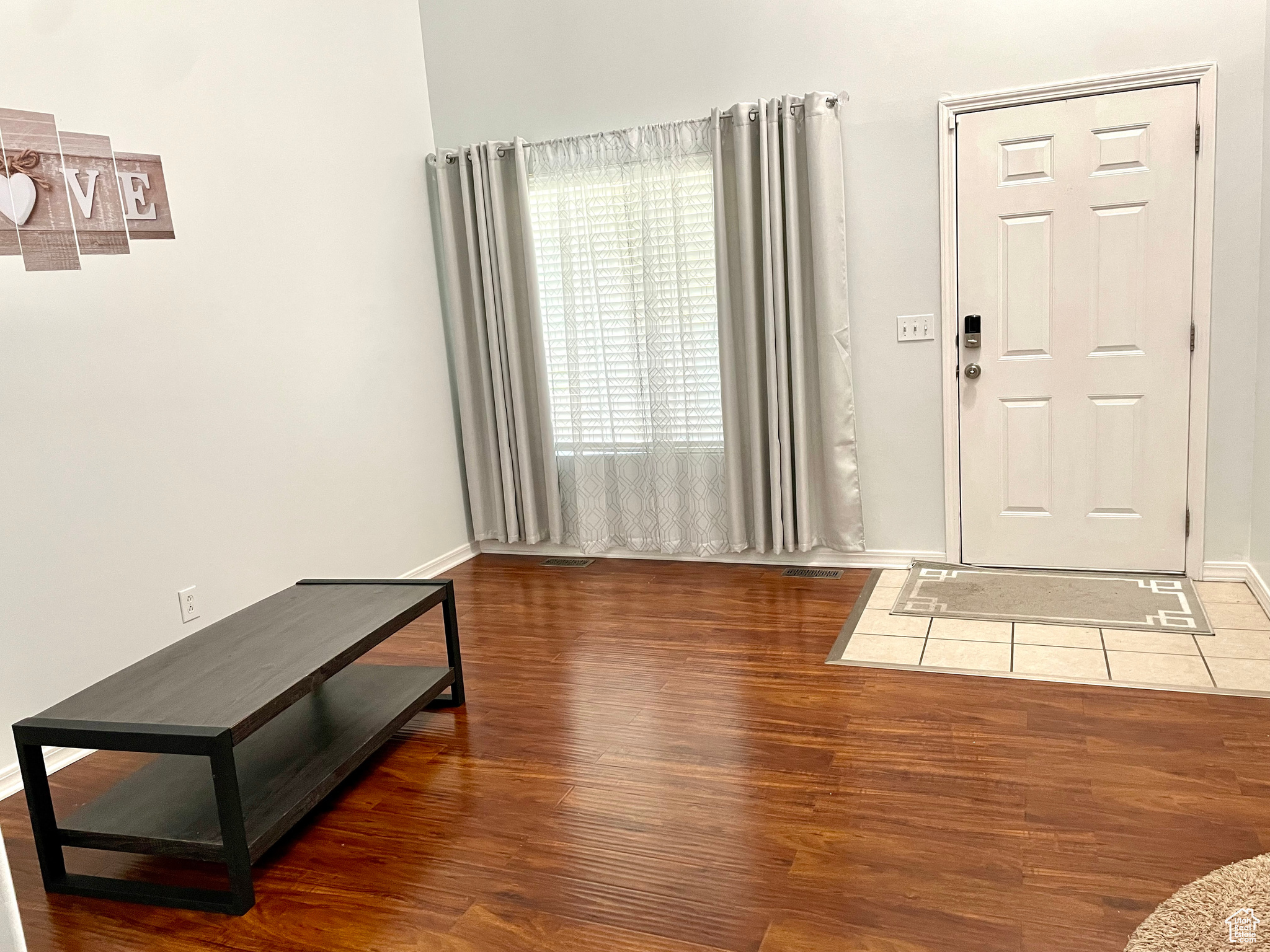 Entrance foyer with wood-type flooring