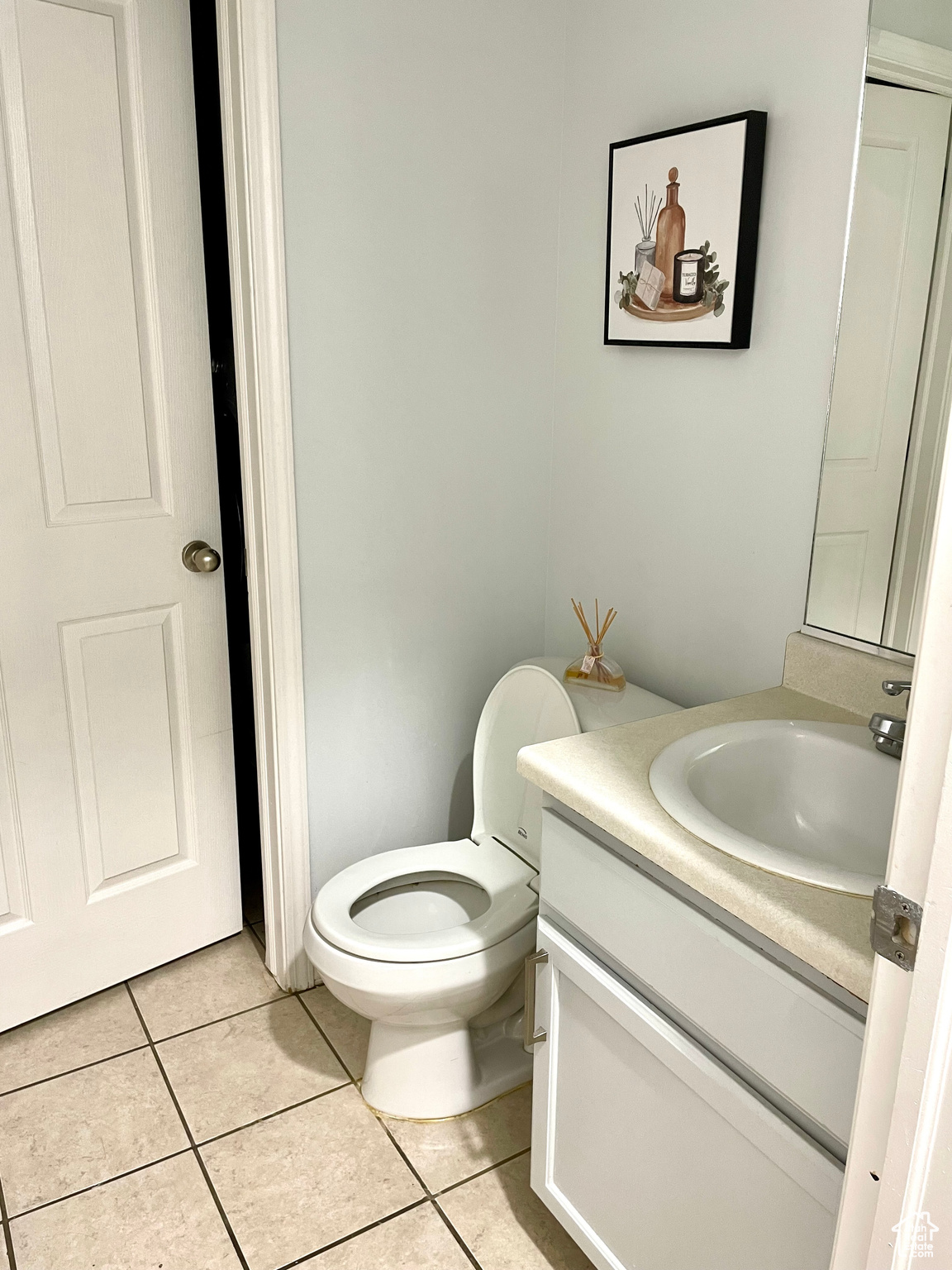 Bathroom featuring vanity, toilet, and tile patterned floors