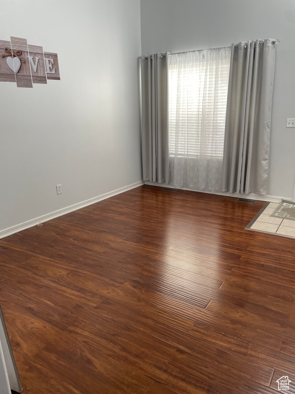 Empty room featuring dark wood-type flooring