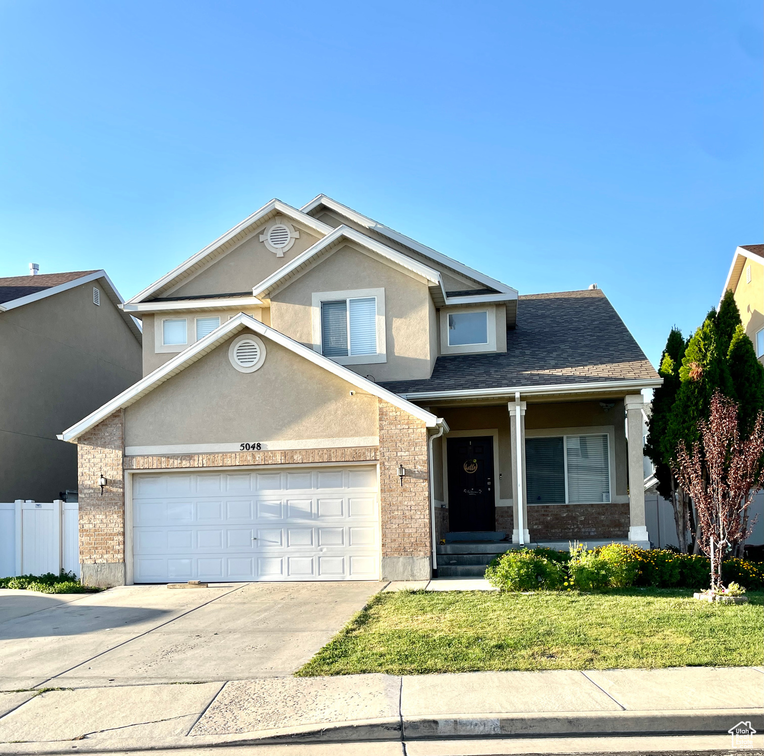 Front of property featuring a garage and a front yard