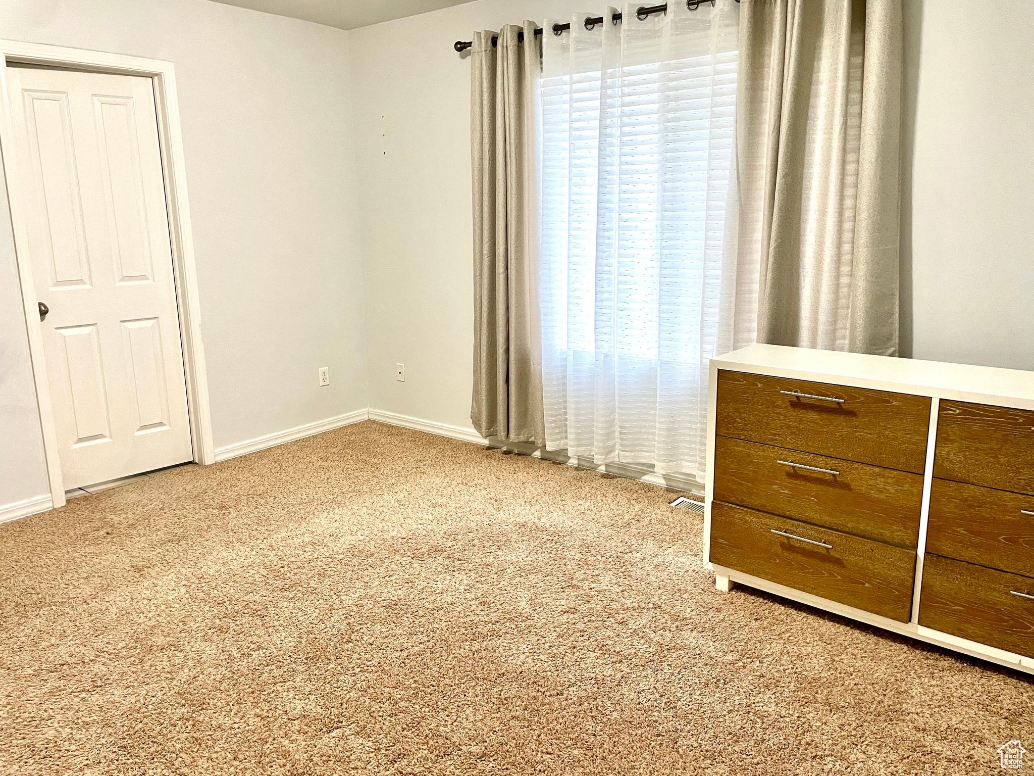 Unfurnished bedroom with carpet