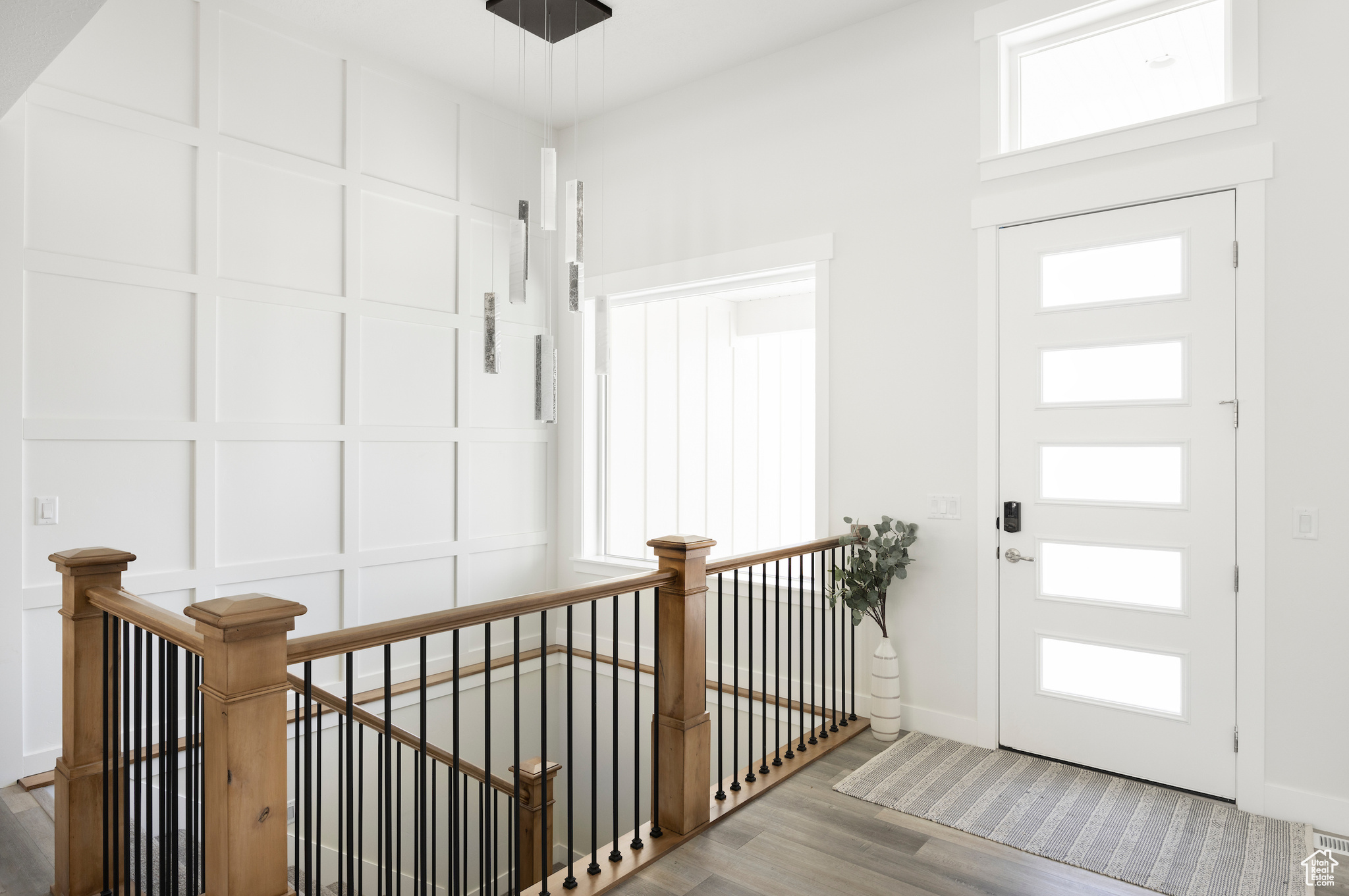 Entryway with plenty of natural light and wood-type flooring