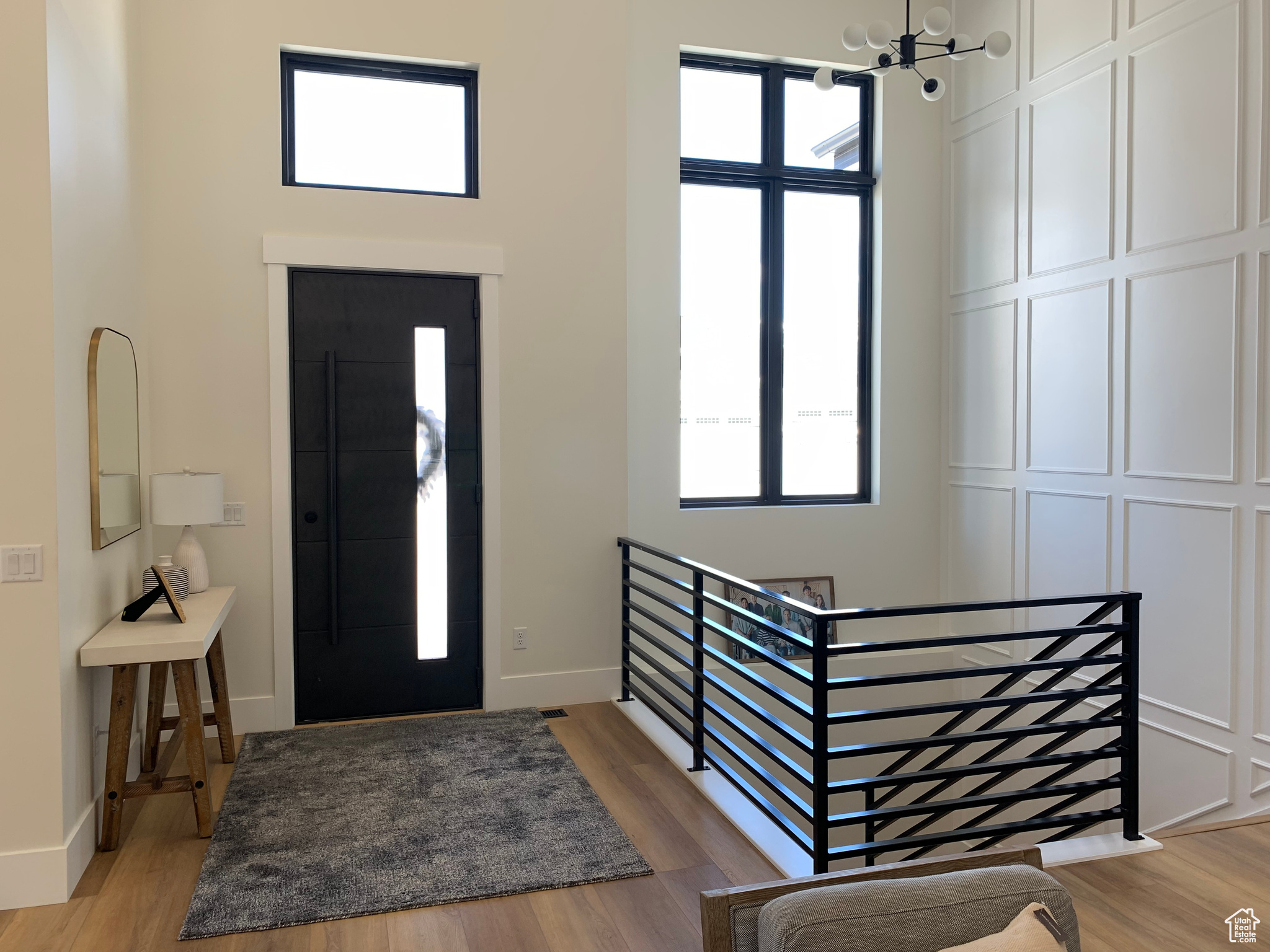 Foyer featuring light hardwood / wood-style flooring and an inviting chandelier