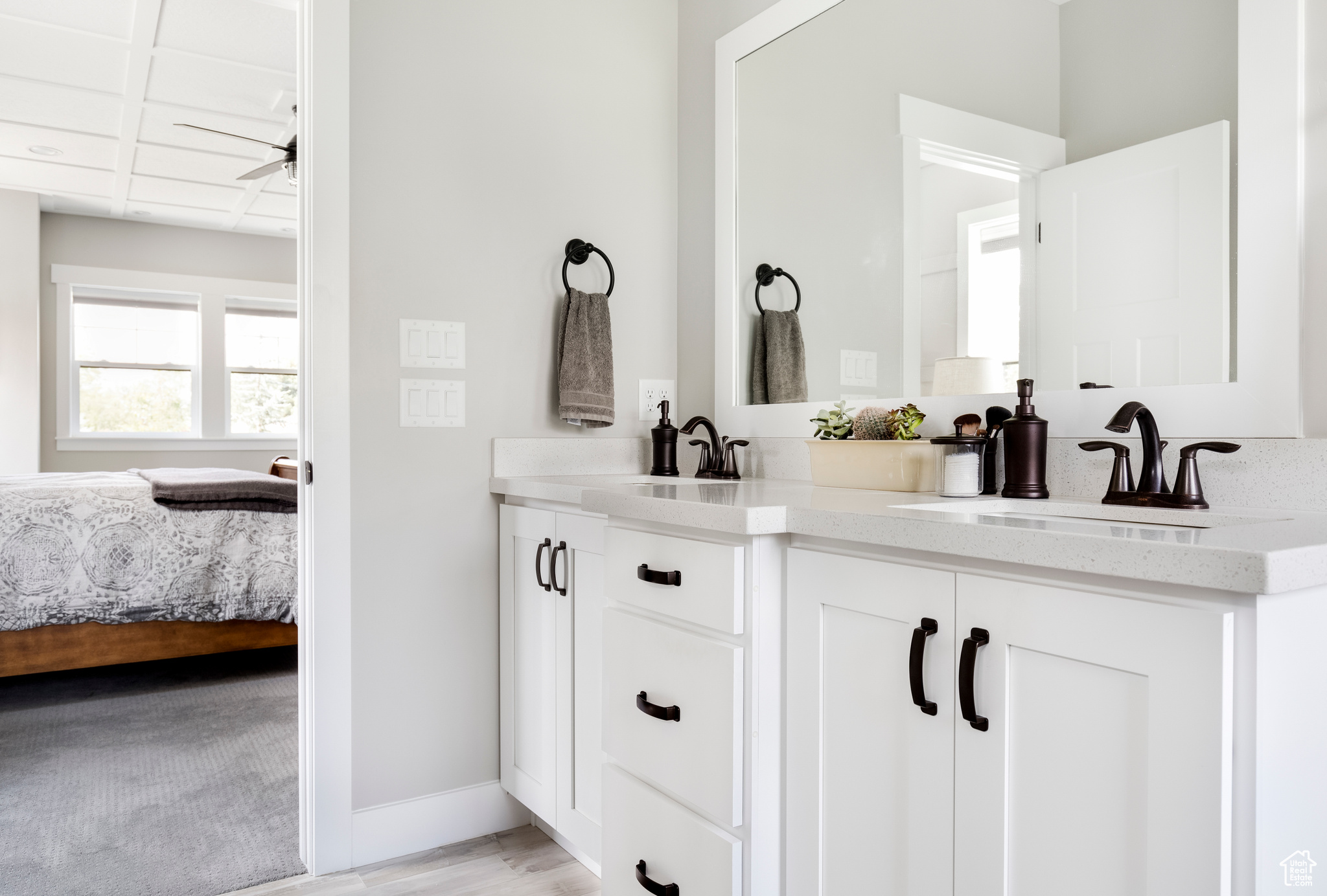 Bathroom with vanity, ceiling fan, and wood-type flooring