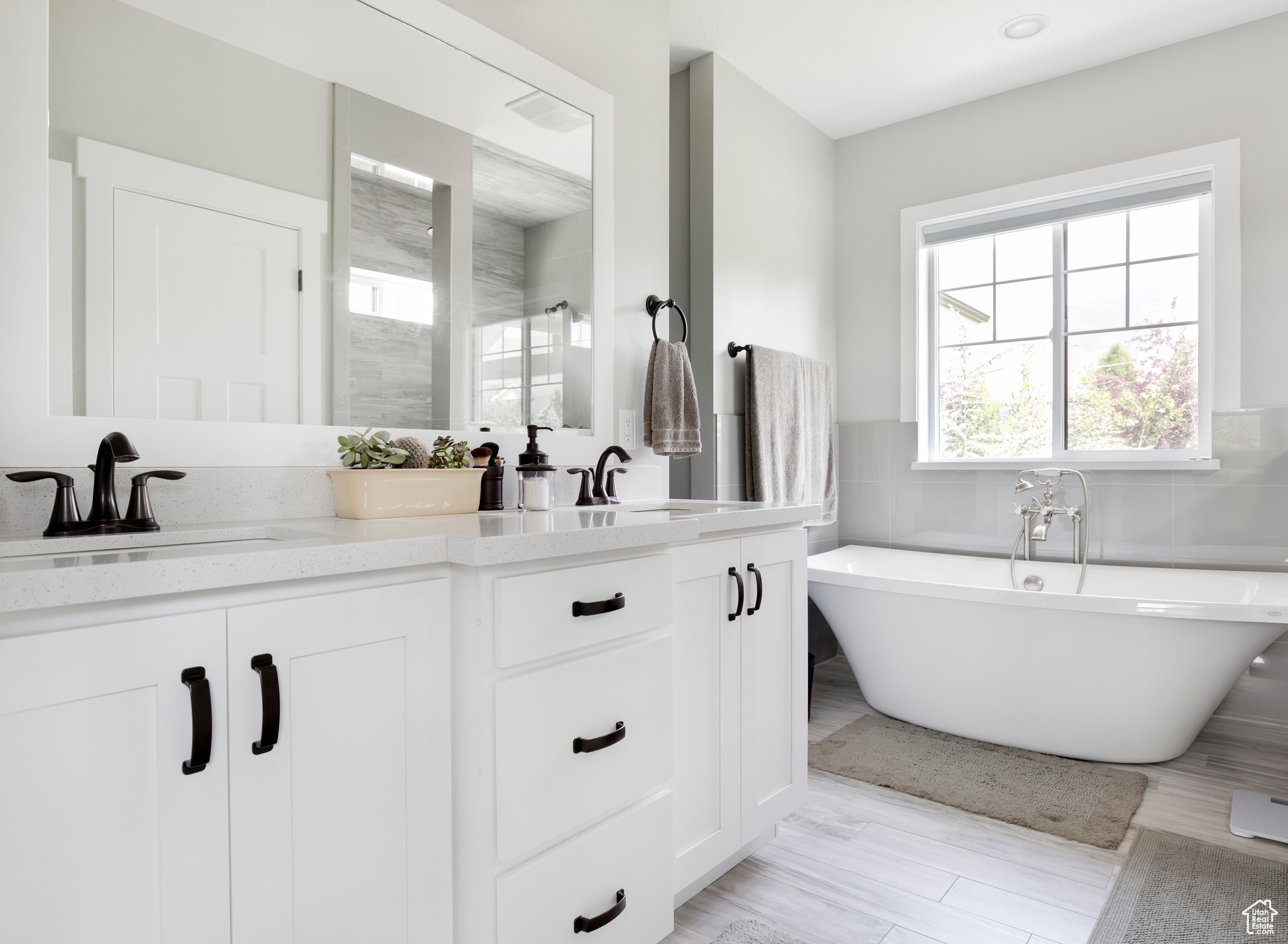 Bathroom with plus walk in shower, hardwood / wood-style flooring, and vanity