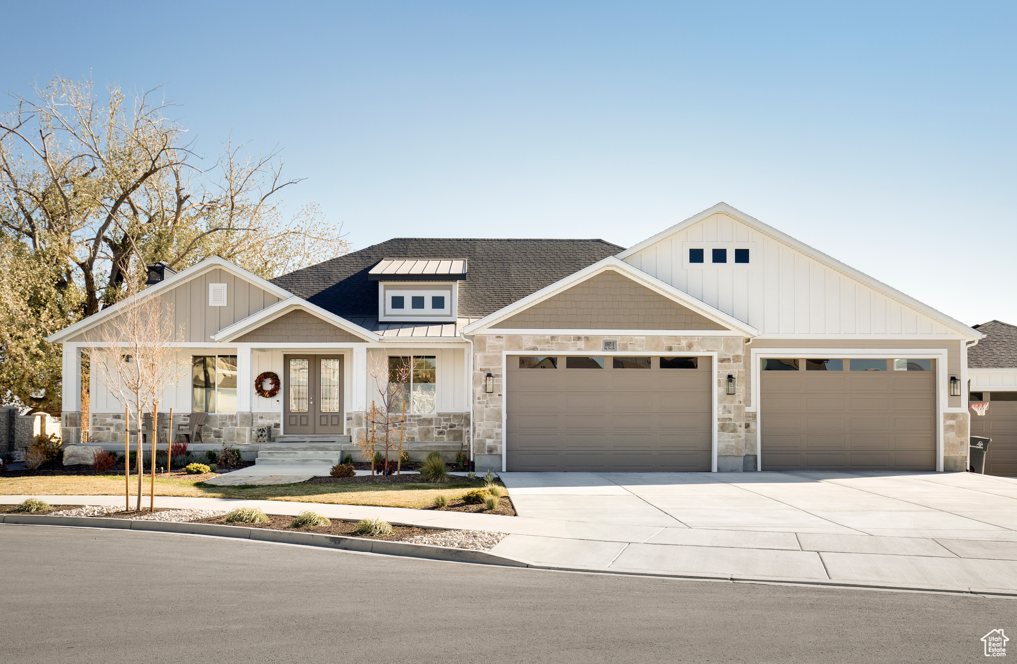 View of front of property featuring a garage and covered porch