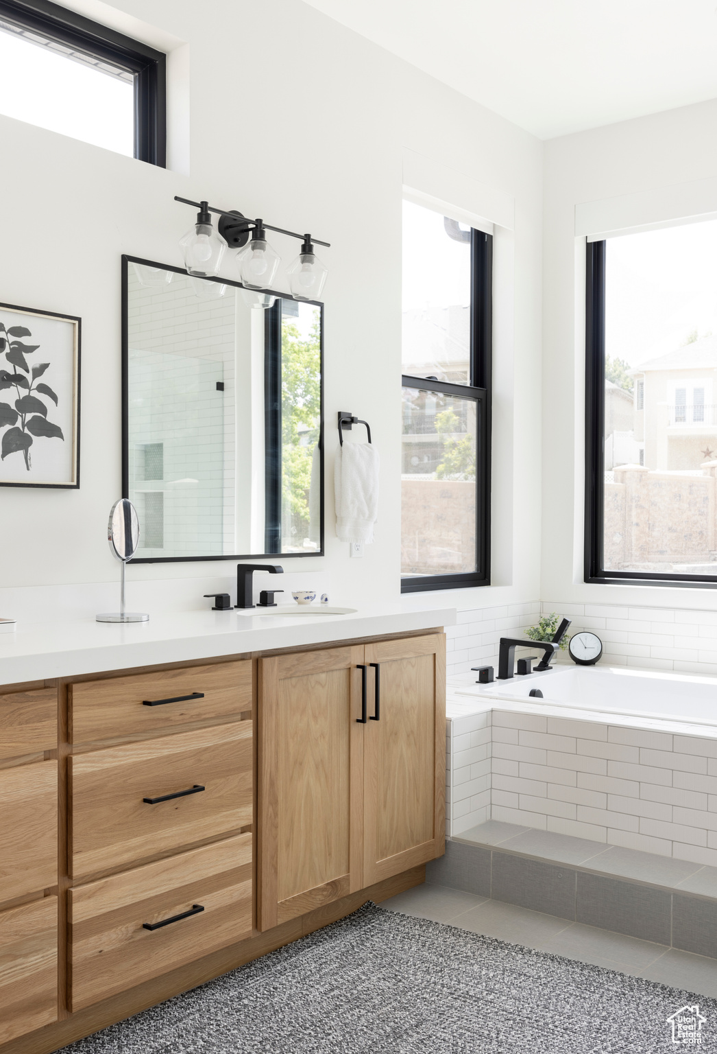 Bathroom with a wealth of natural light, vanity, and separate shower and tub