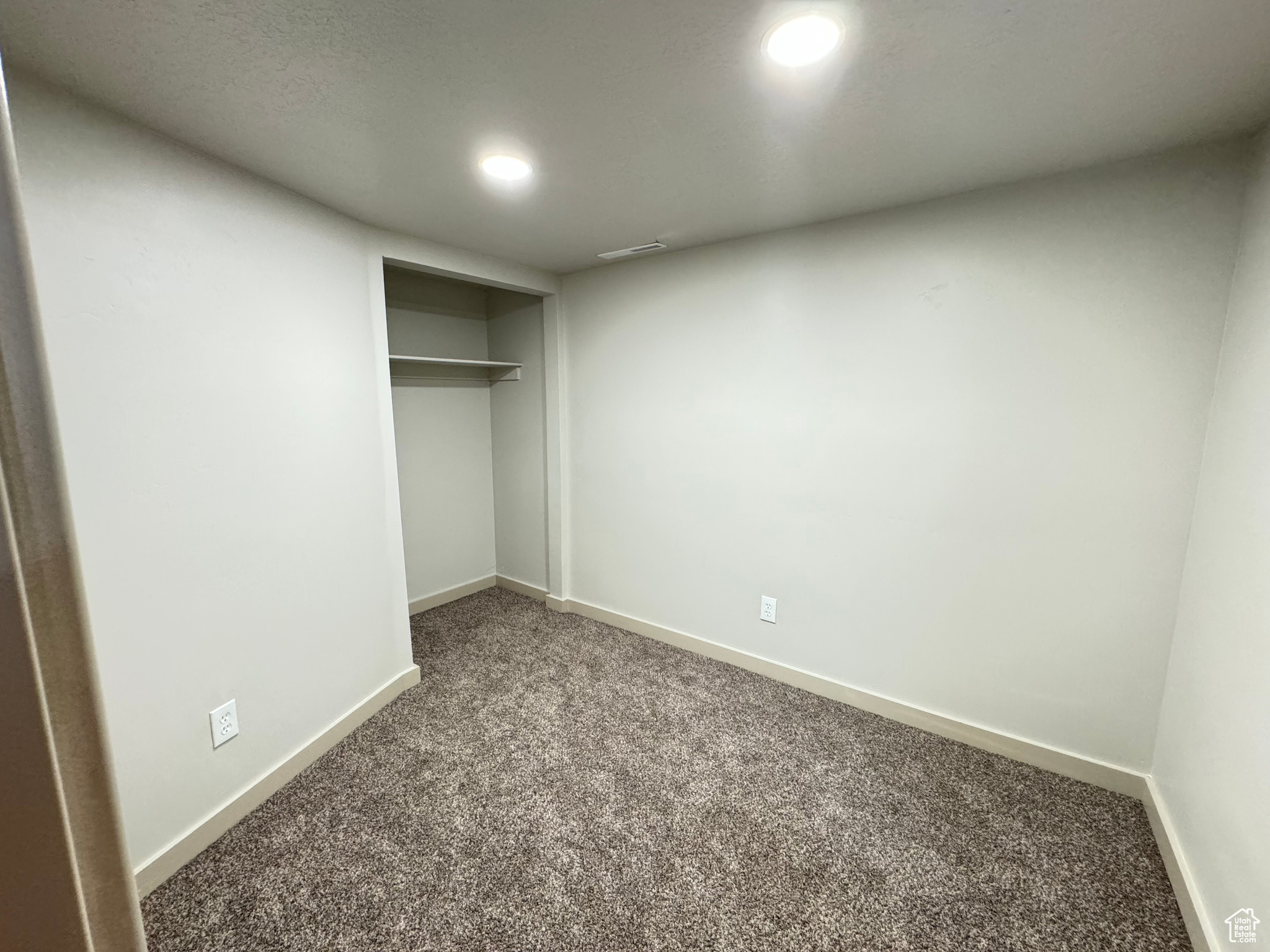 Unfurnished bedroom featuring a closet and carpet flooring