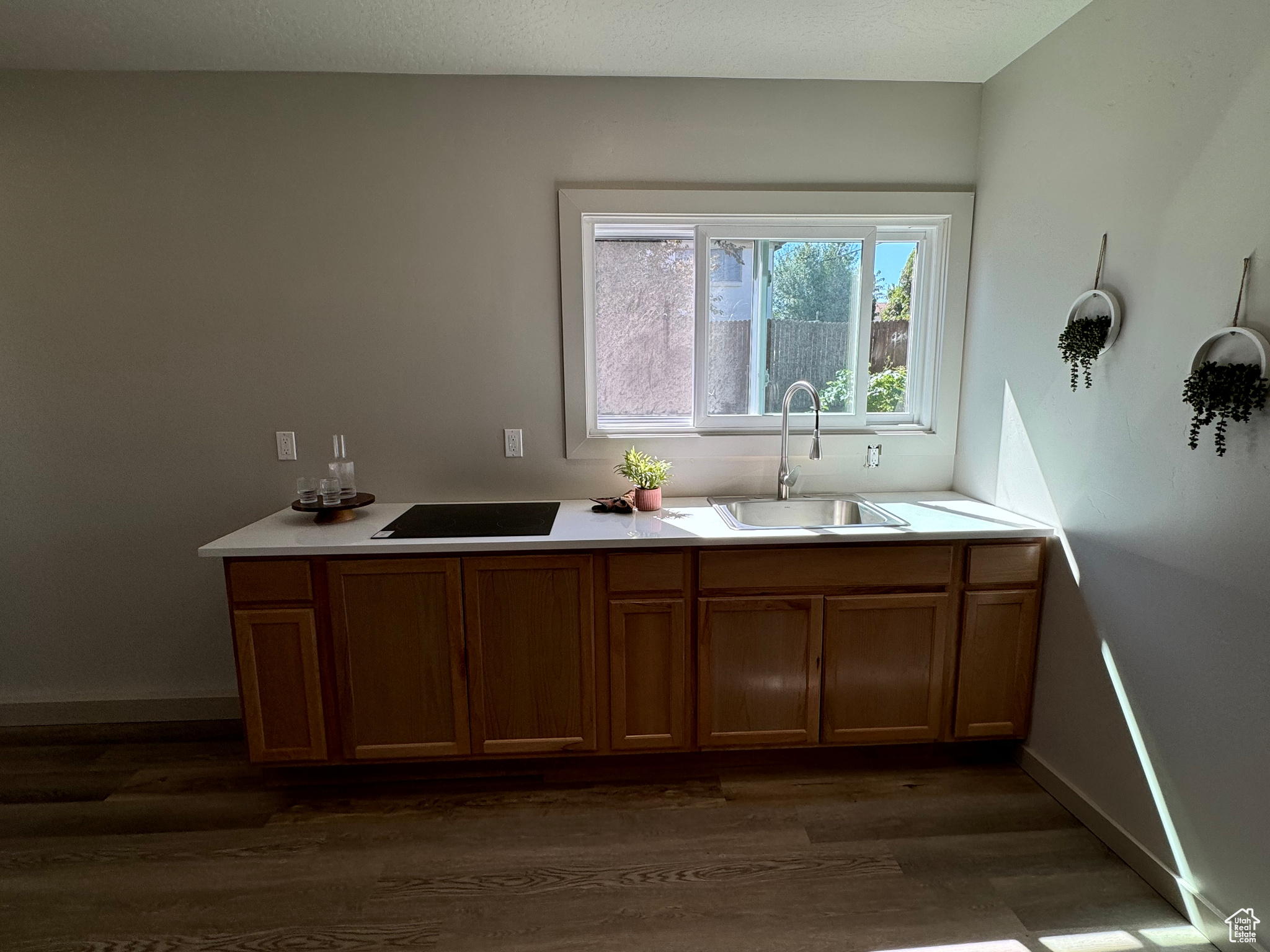 Interior space featuring a textured ceiling, hardwood / wood-style floors, and sink