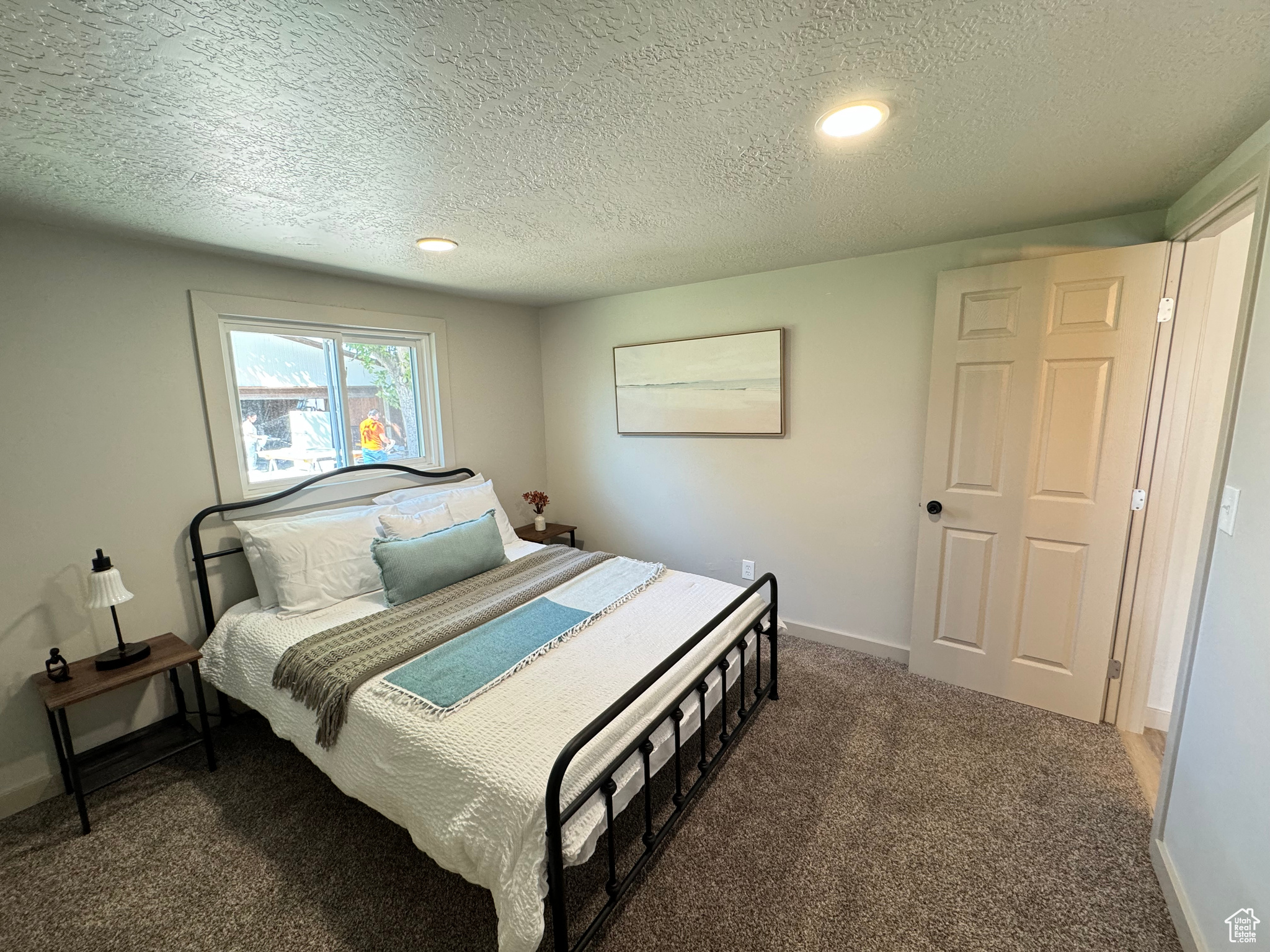 Carpeted bedroom with a textured ceiling