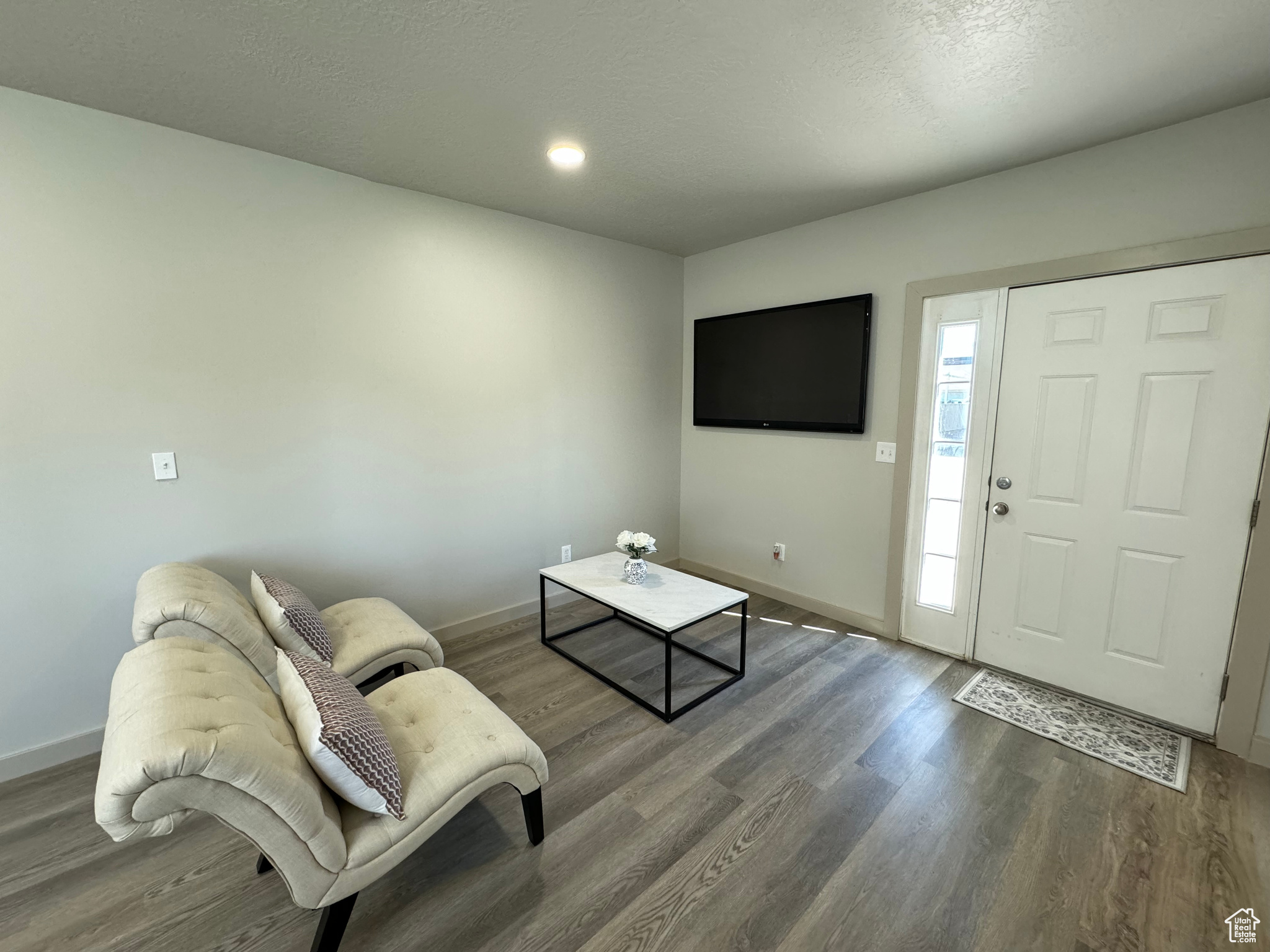 Foyer featuring a textured ceiling and dark hardwood / wood-style flooring