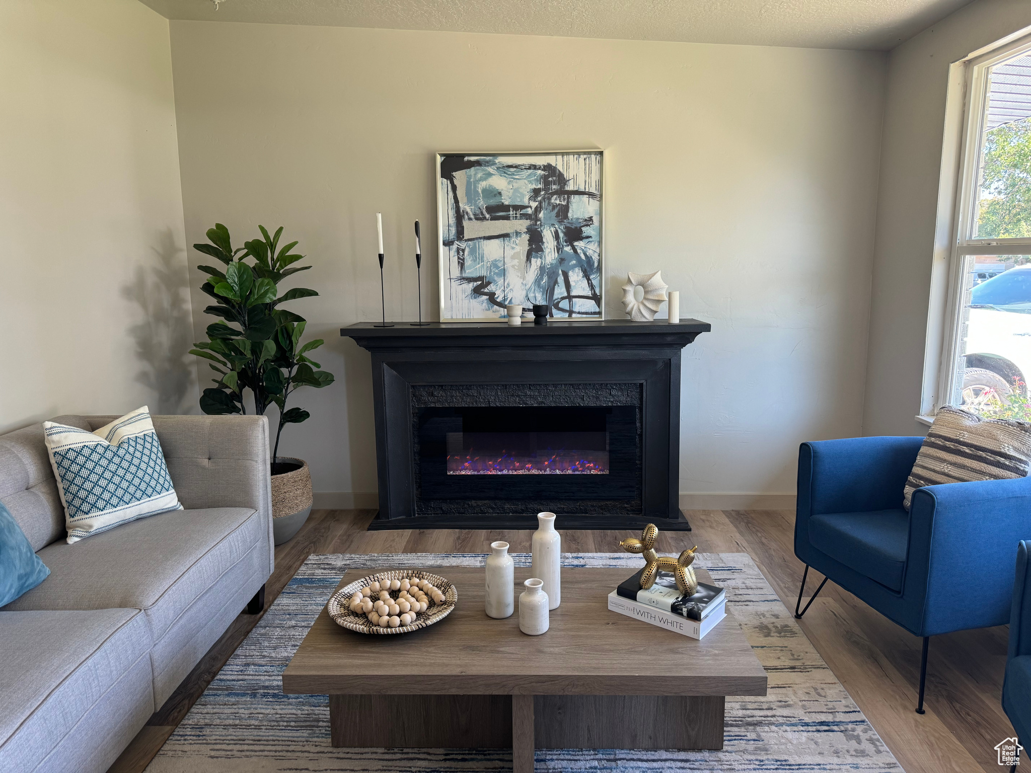 Living room with a textured ceiling and hardwood / wood-style floors