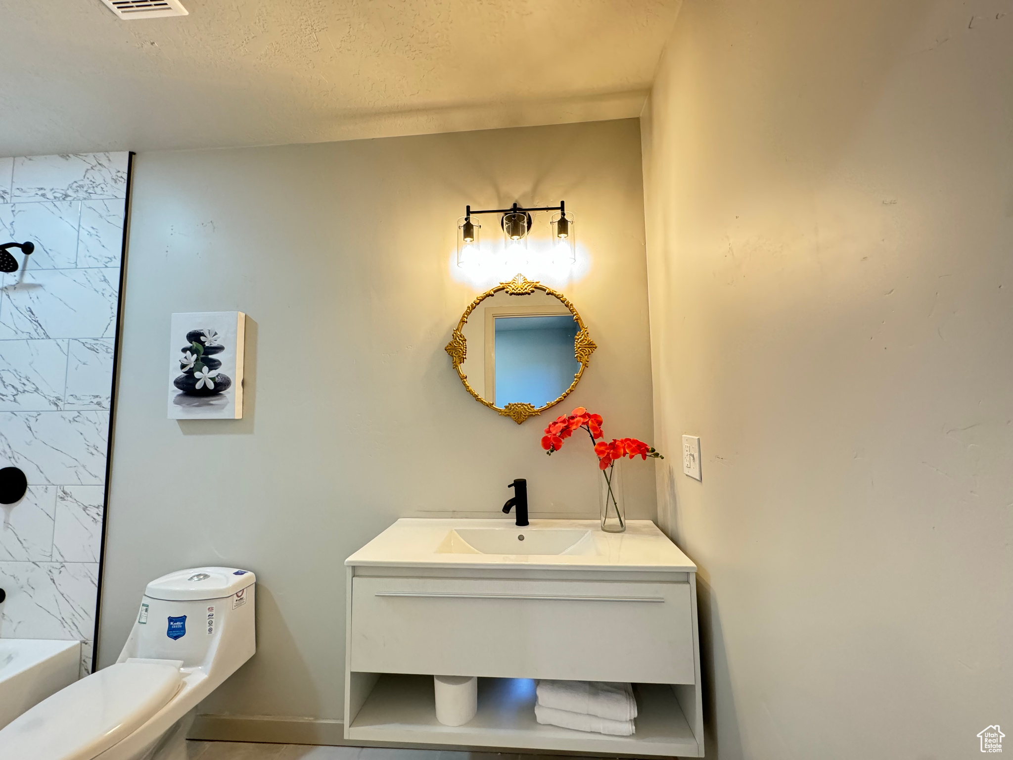 Full bathroom featuring vanity, toilet, shower with separate bathtub, and a textured ceiling