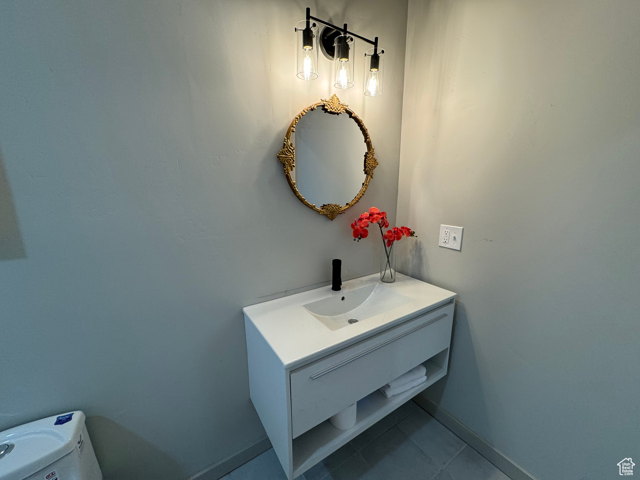 Bathroom featuring vanity, toilet, and tile patterned floors