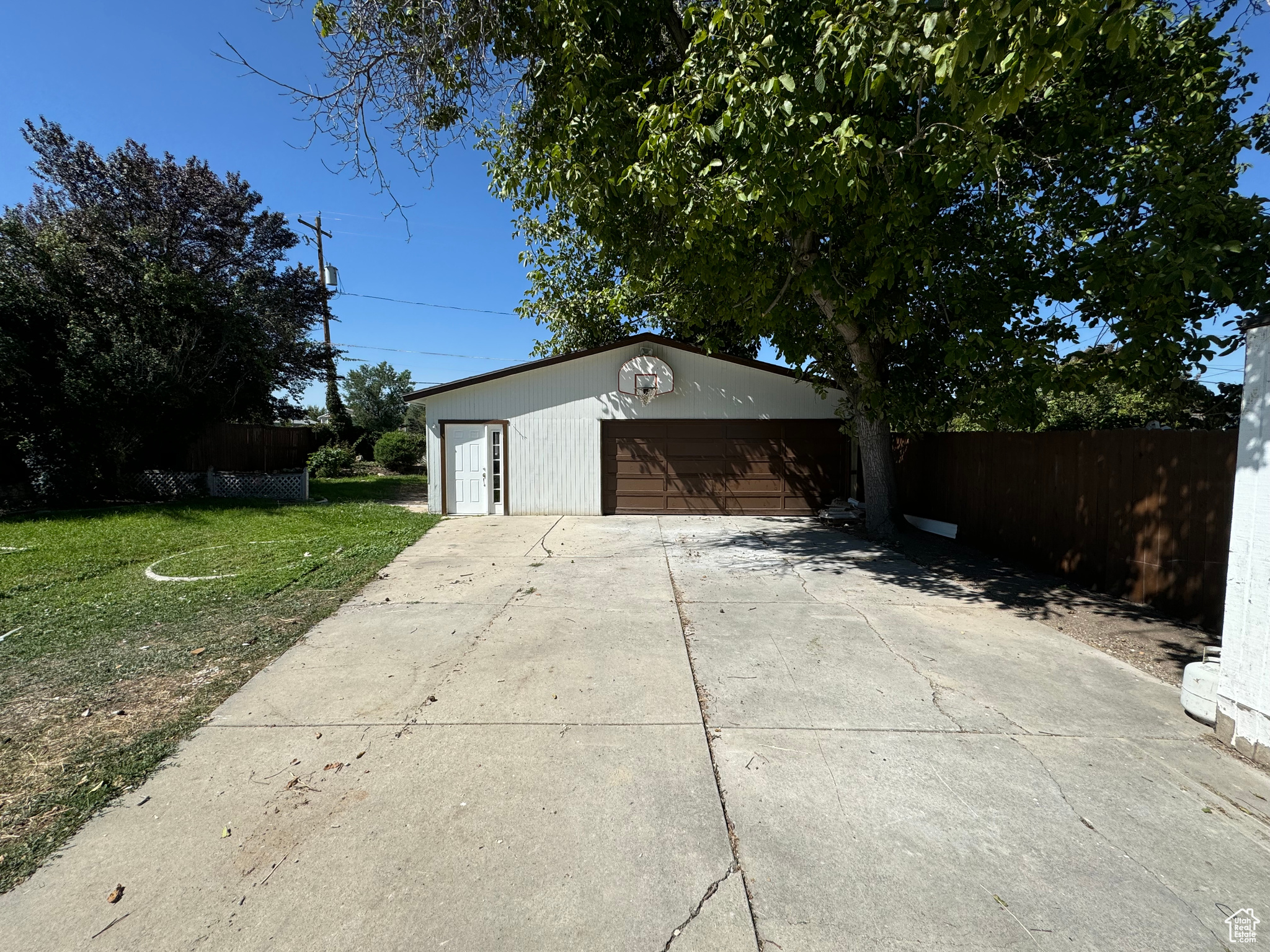 Garage featuring a lawn