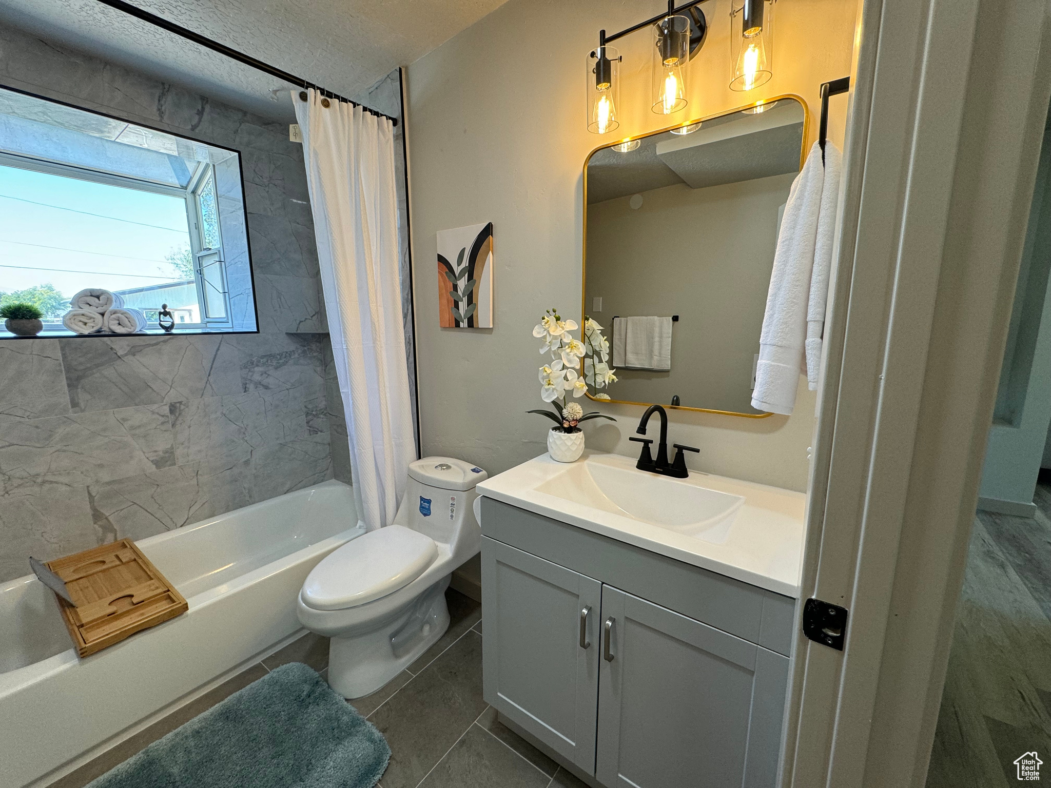 Full bathroom featuring toilet, tile patterned flooring, vanity, a textured ceiling, and shower / bath combination with curtain