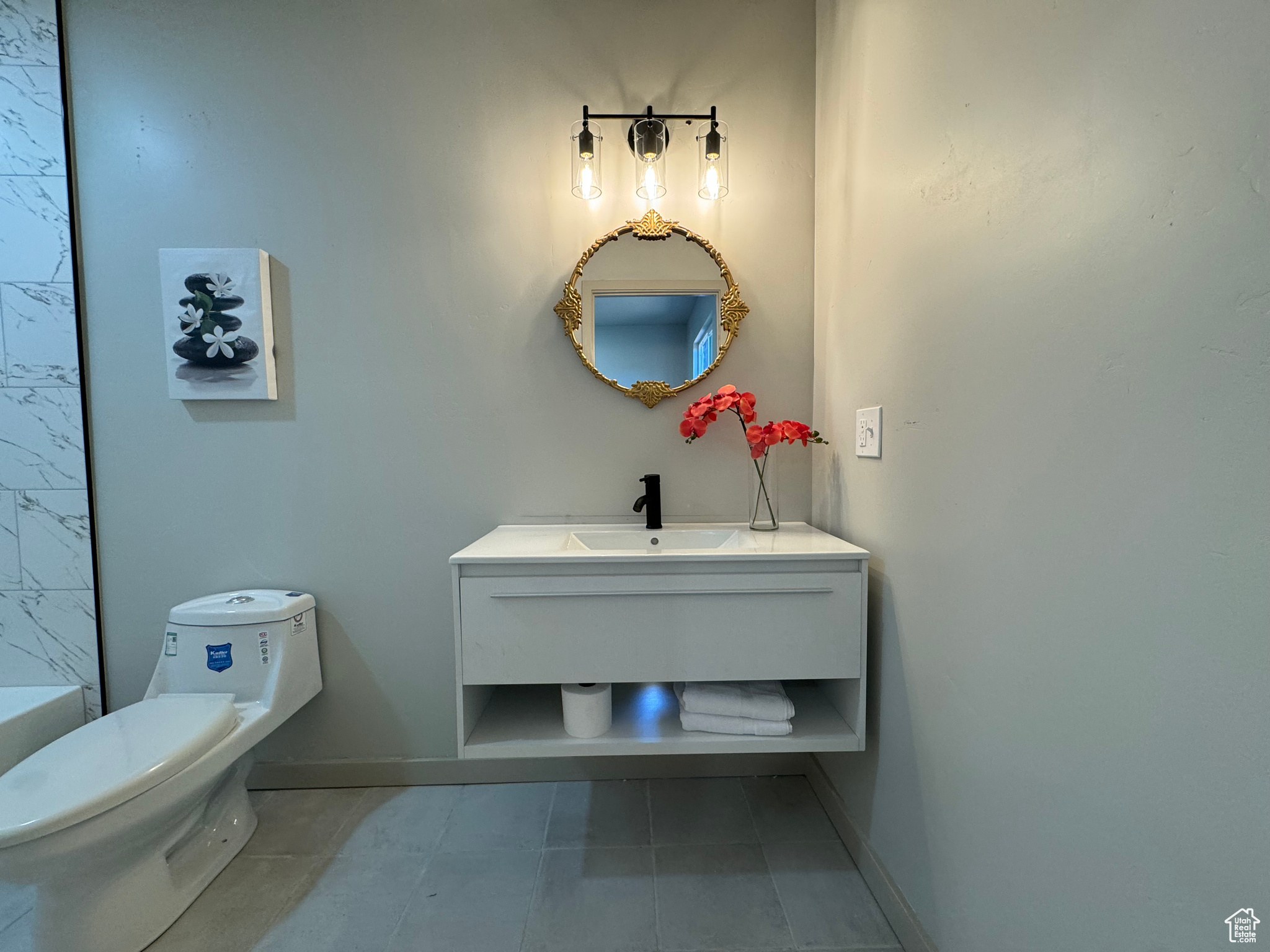 Bathroom featuring vanity, toilet, and tile patterned floors