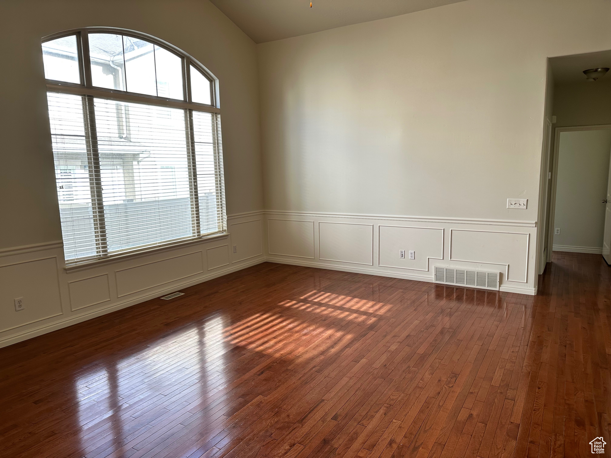 Spare room with dark wood-type flooring