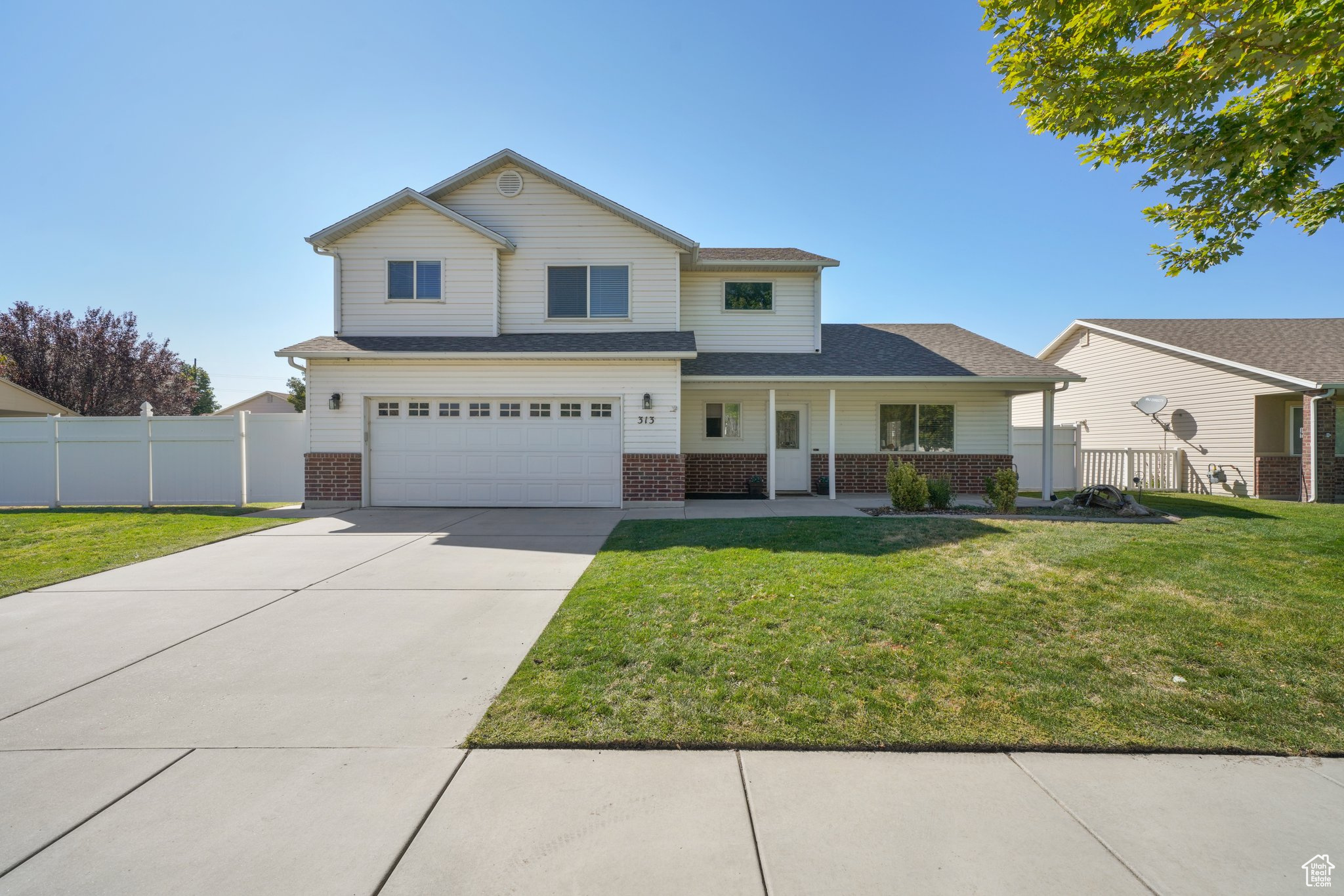 Front facade featuring a garage and a front yard