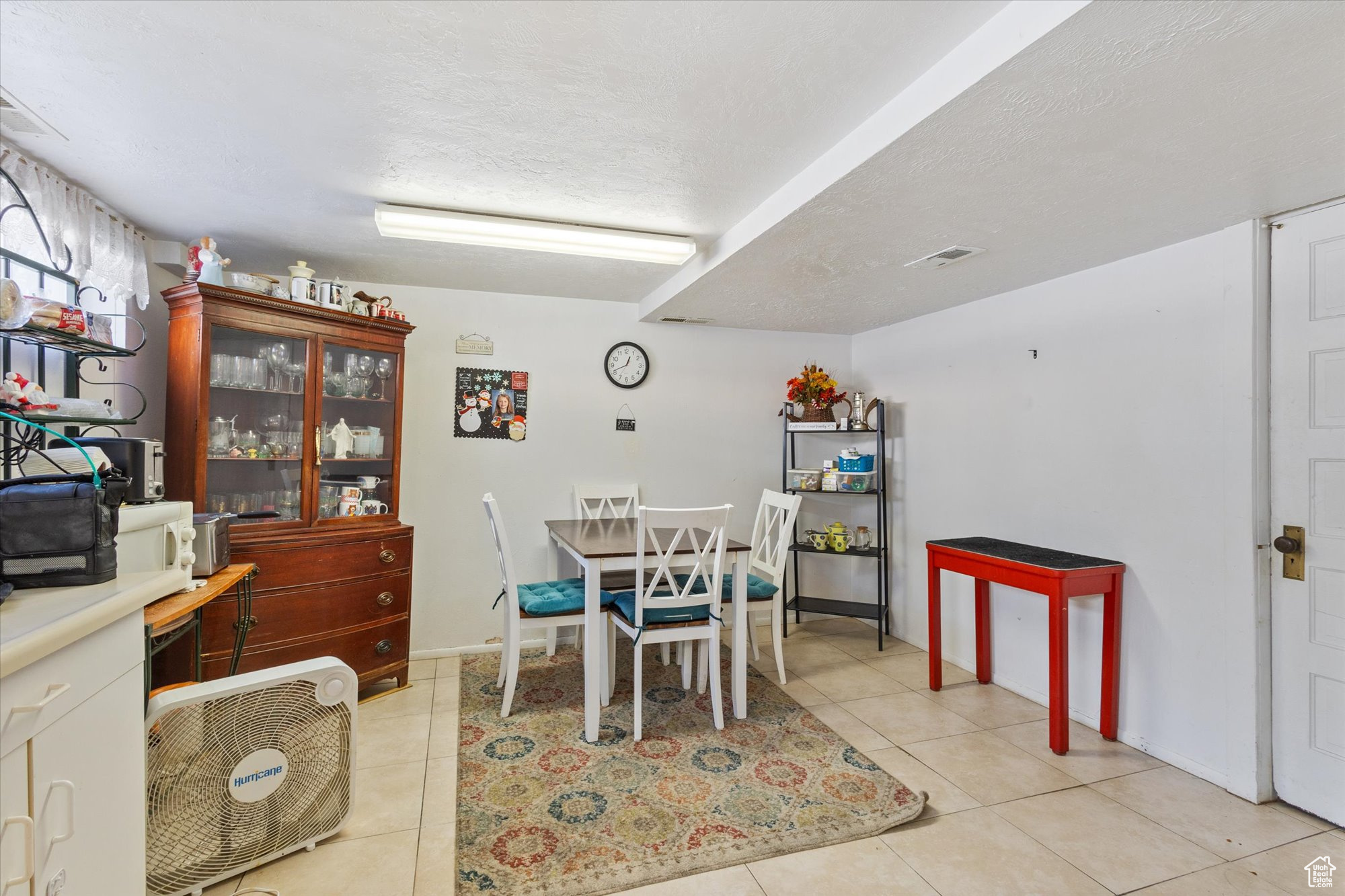 Tiled dining room featuring a textured ceiling