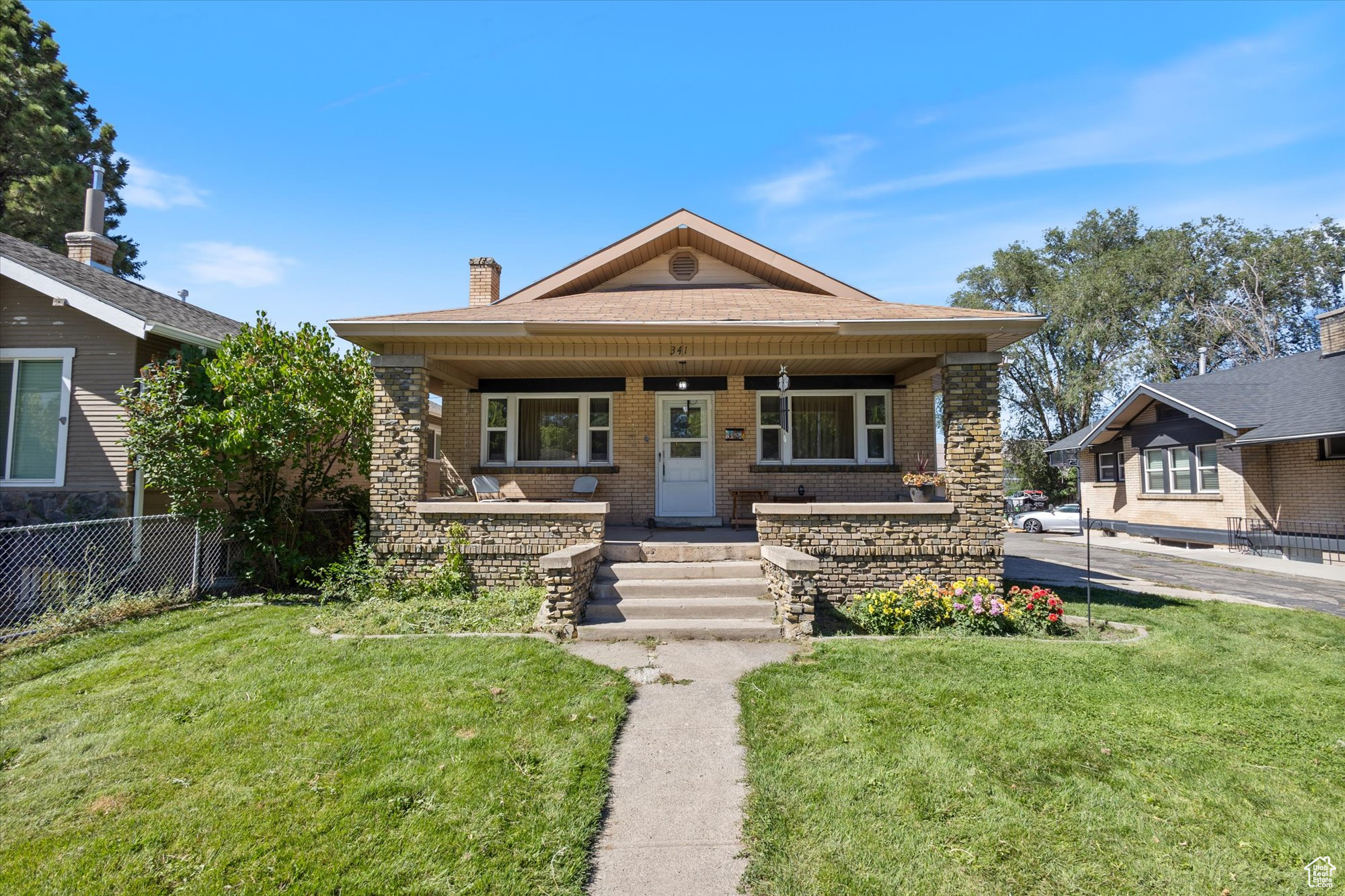 View of front of house with a porch and a front lawn