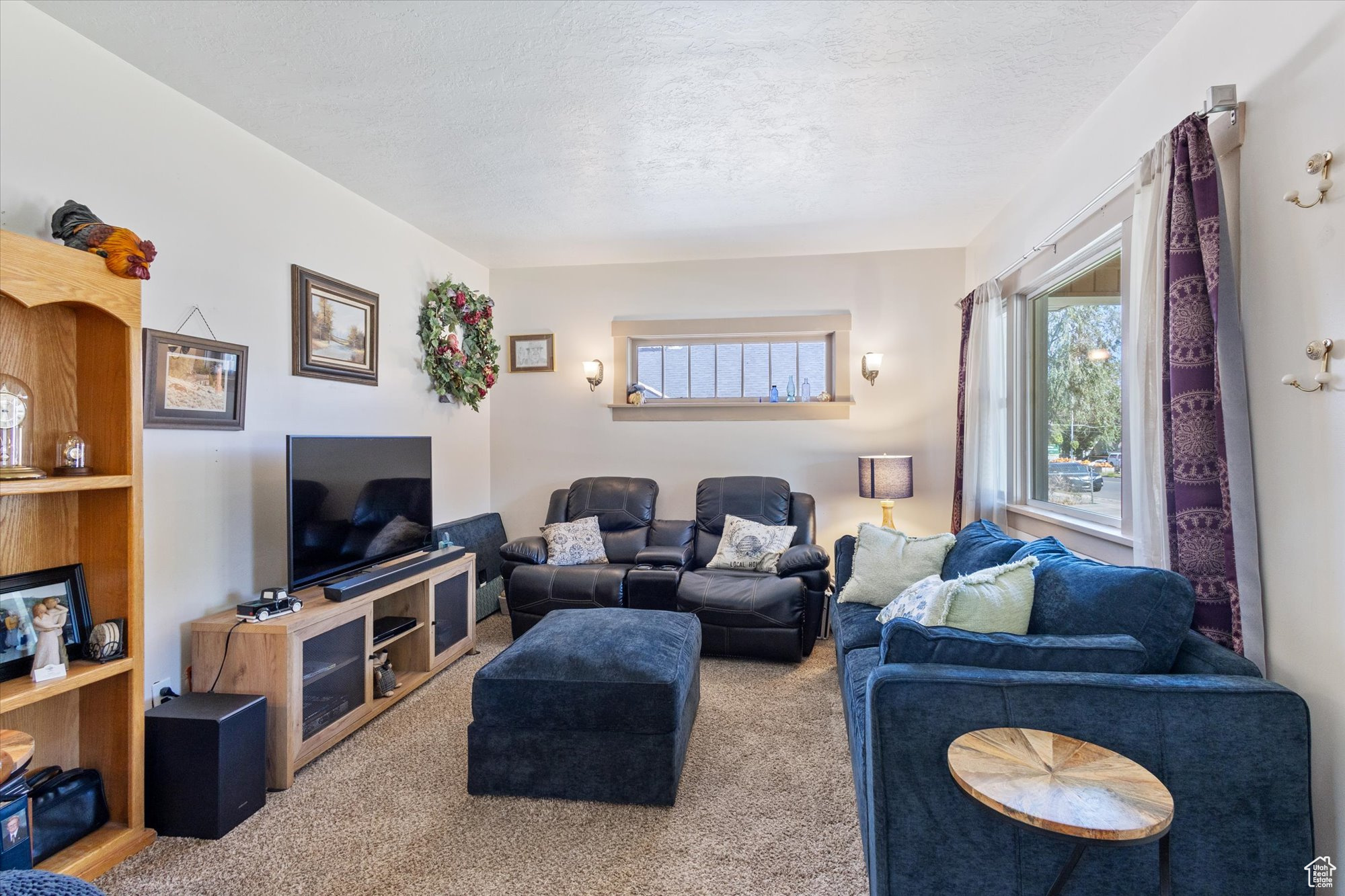 Living room with a textured ceiling and carpet floors