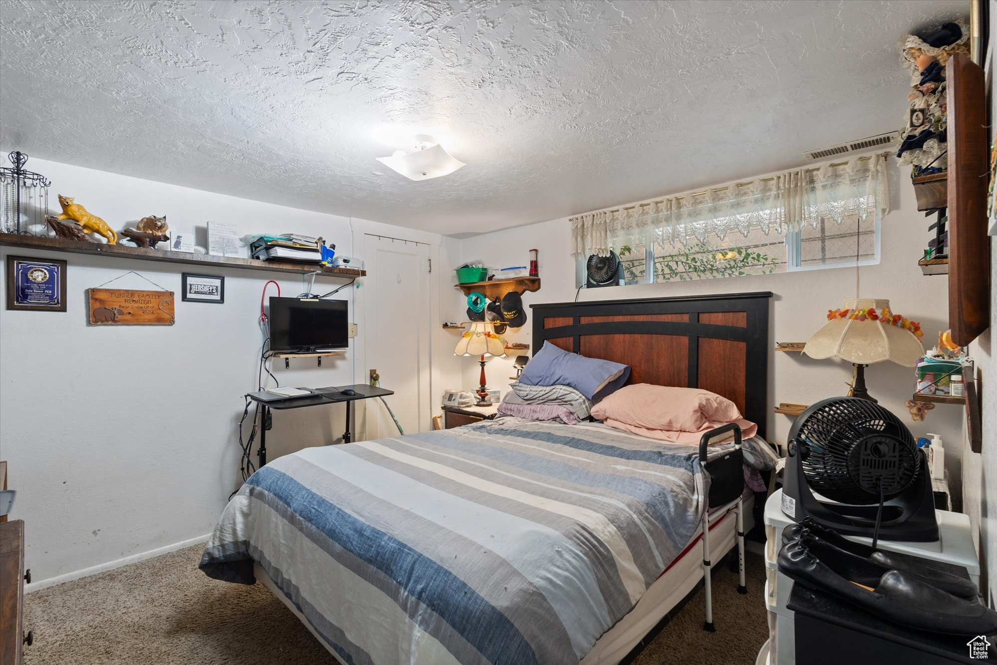 Bedroom featuring a textured ceiling and carpet flooring